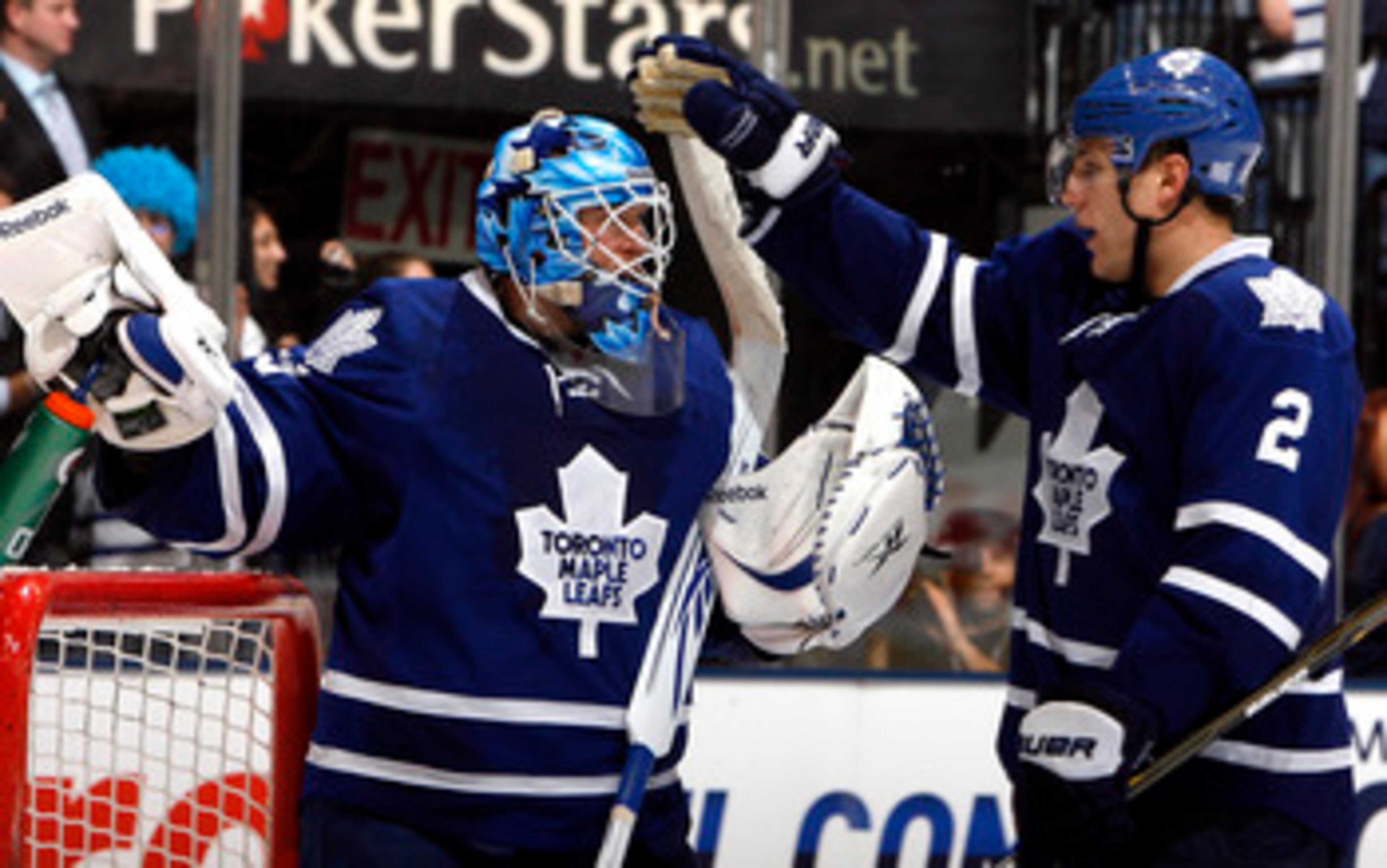 TORONTO - OCTOBER 26: Jean-Sebastien Giguere #35 and Luke Schenn #2 of the Toronto Maple Leafs celebrate win against the Florida Panthers during game action at the Air Canada Centre October 26, 2010 in Toronto, Ontario, Canada. The Leafs won 3-1. (Photo b