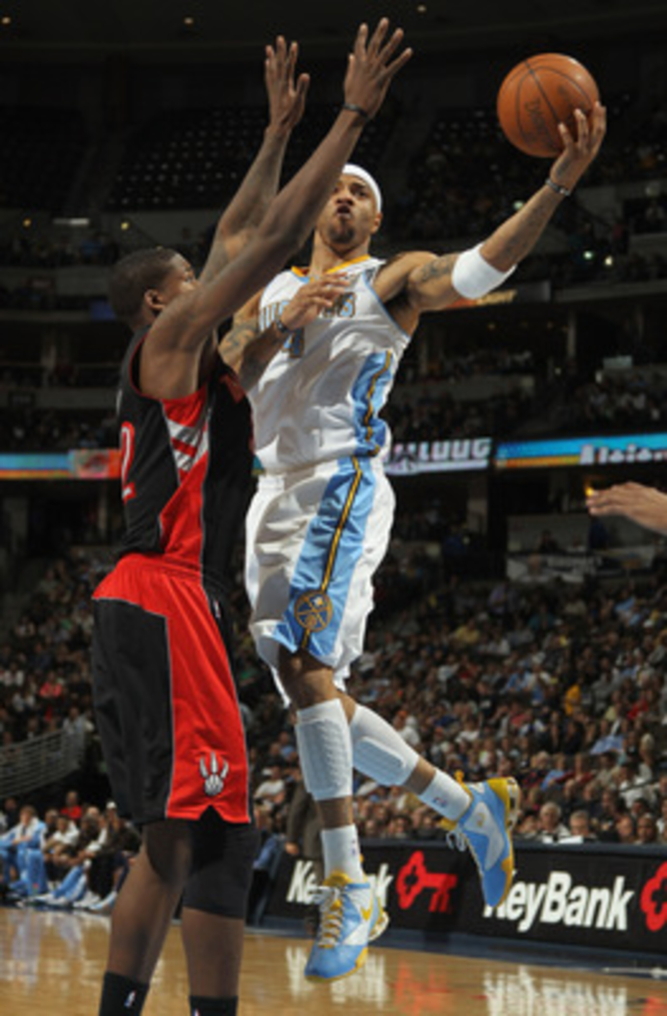 DENVER, CO - MARCH 21:  Kenyon Martin #4 of the Denver Nuggets lays up a shot against Ed Davis #32 of the Toronto Raptors at the Pepsi Center on March 21, 2011 in Denver, Colorado. The Nuggets defeated the Raptors 123-90. NOTE TO USER: User expressly ackn