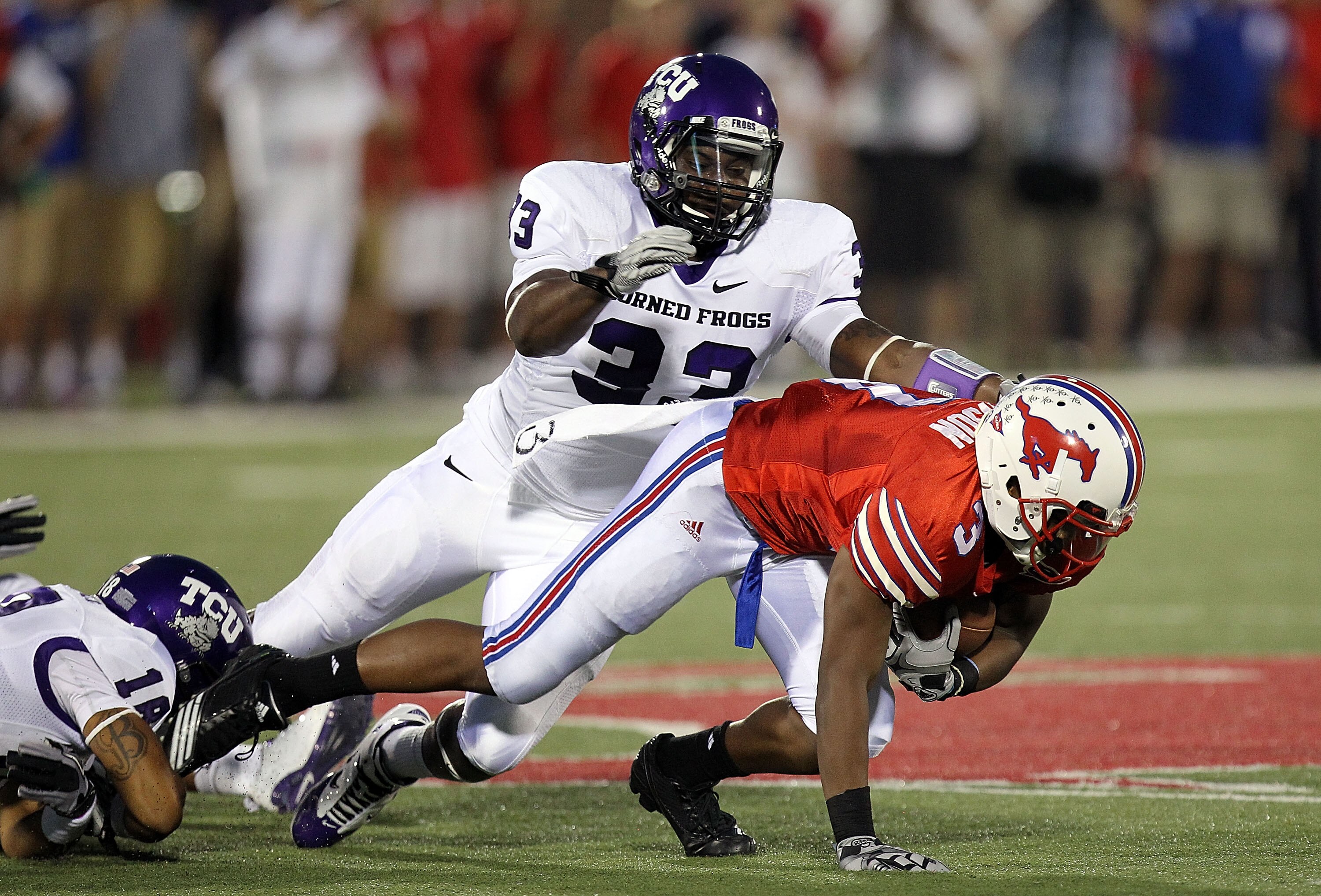 DALLAS - SEPTEMBER 24:  Wide receiver Darius Johnson #3 of the SMU Mustangs is tackled by Kris Gardner #33 of the TCU Horned Frogs at Gerald J. Ford Stadium on September 24, 2010 in Dallas, Texas.  (Photo by Ronald Martinez/Getty Images)