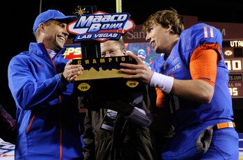 LAS VEGAS, NV - DECEMBER 22:  Head coach Chris Petersen (L) and quarterback Kellen Moore #11 of the Boise State Broncos hold up a trophy as they celebrate their 26-3 victory over the Utah Utes in the MAACO Bowl Las Vegas at Sam Boyd Stadium December 22, 2