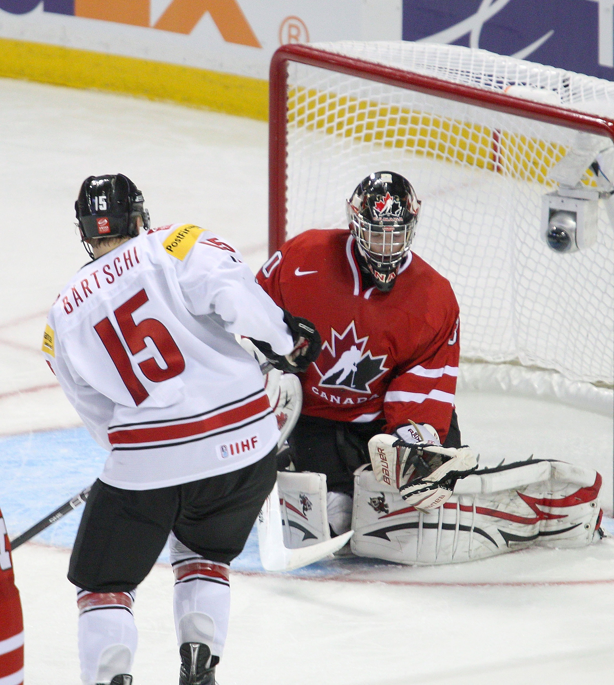 BUFFALO, NY - JANUARY 02: Mark Visentin #30 of Canada makes a save on Sven Bartschi #15 of Switzerland during the 2011 IIHF World U20 Championship game between Canada and Switzerland on January 2, 2011 in Buffalo, New York. Canada won 4-1. (Photo by Rick