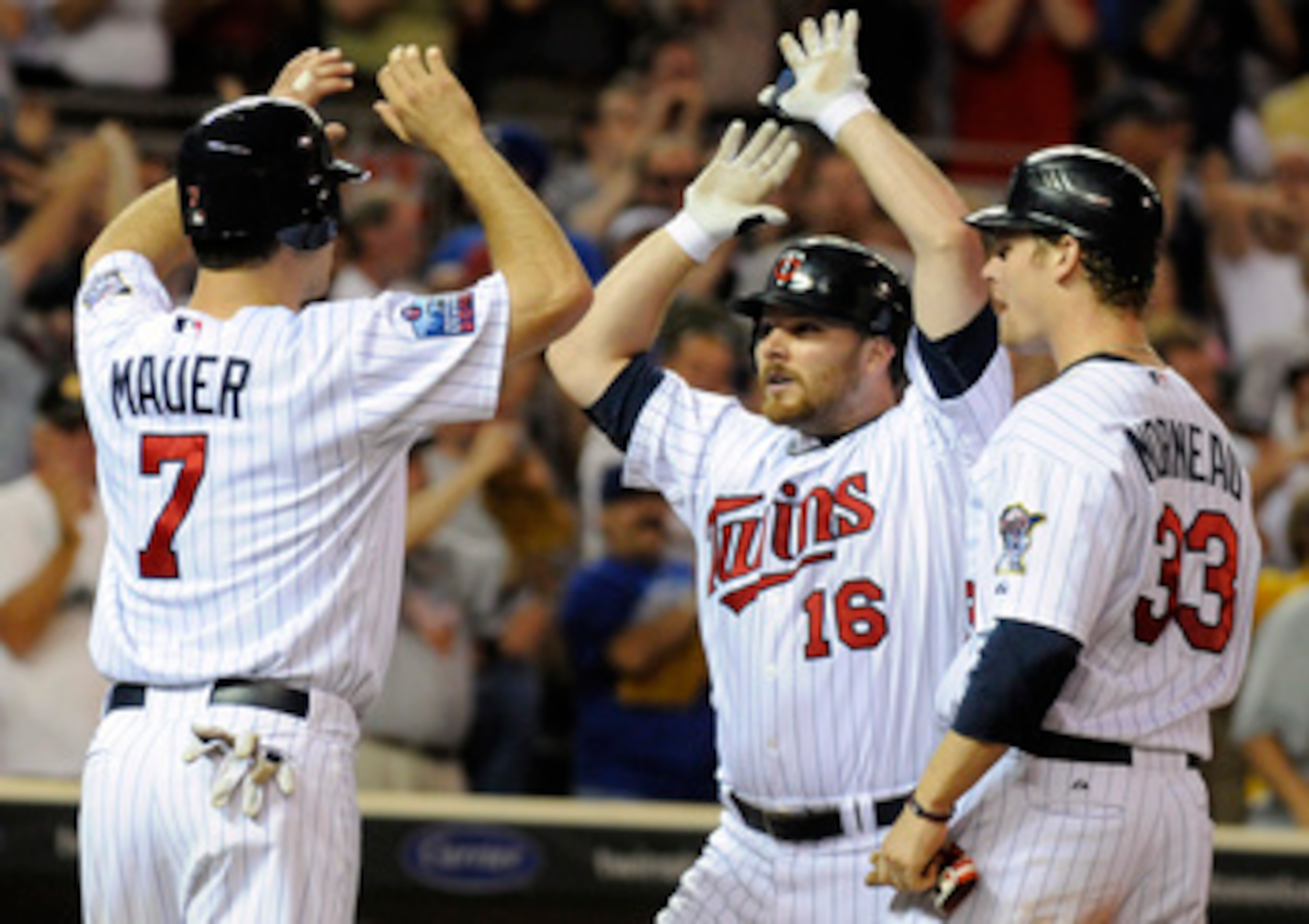 MINNEAPOLIS, MN - MAY 27: Joe Mauer #7, Jason Kubel #16 and Justin Morneau #33 of the Minnesota Twins celebrate a three-run home run by Kubel in the eighth inning against the New York Yankees during their game on May 27, 2010 at Target Field in Minneapoli MINNEAPOLIS, MN - MAY 27: Joe Mauer #7, Jason Kubel #16 and Justin Morneau #33 of the Minnesota Twins celebrate a three-run home run by Kubel in the eighth inning against the New York Yankees during their game on May 27, 2010 at Target Field in Minneapoli