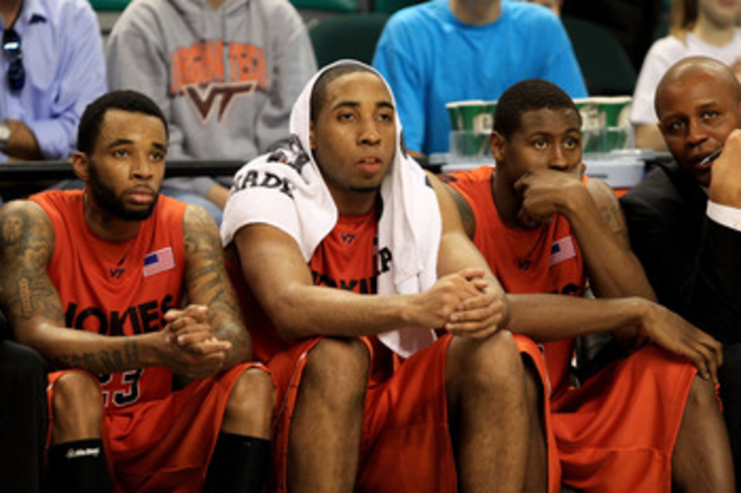 GREENSBORO, NC - MARCH 12:  Malcolm Delaney #23, Victor Davila #14 and Jeff Allen #0 of the Virginia Tech Hokies look on from the bench during the second half against the Duke Blue Devils in the semifinals of the 2011 ACC men's basketball tournament at th