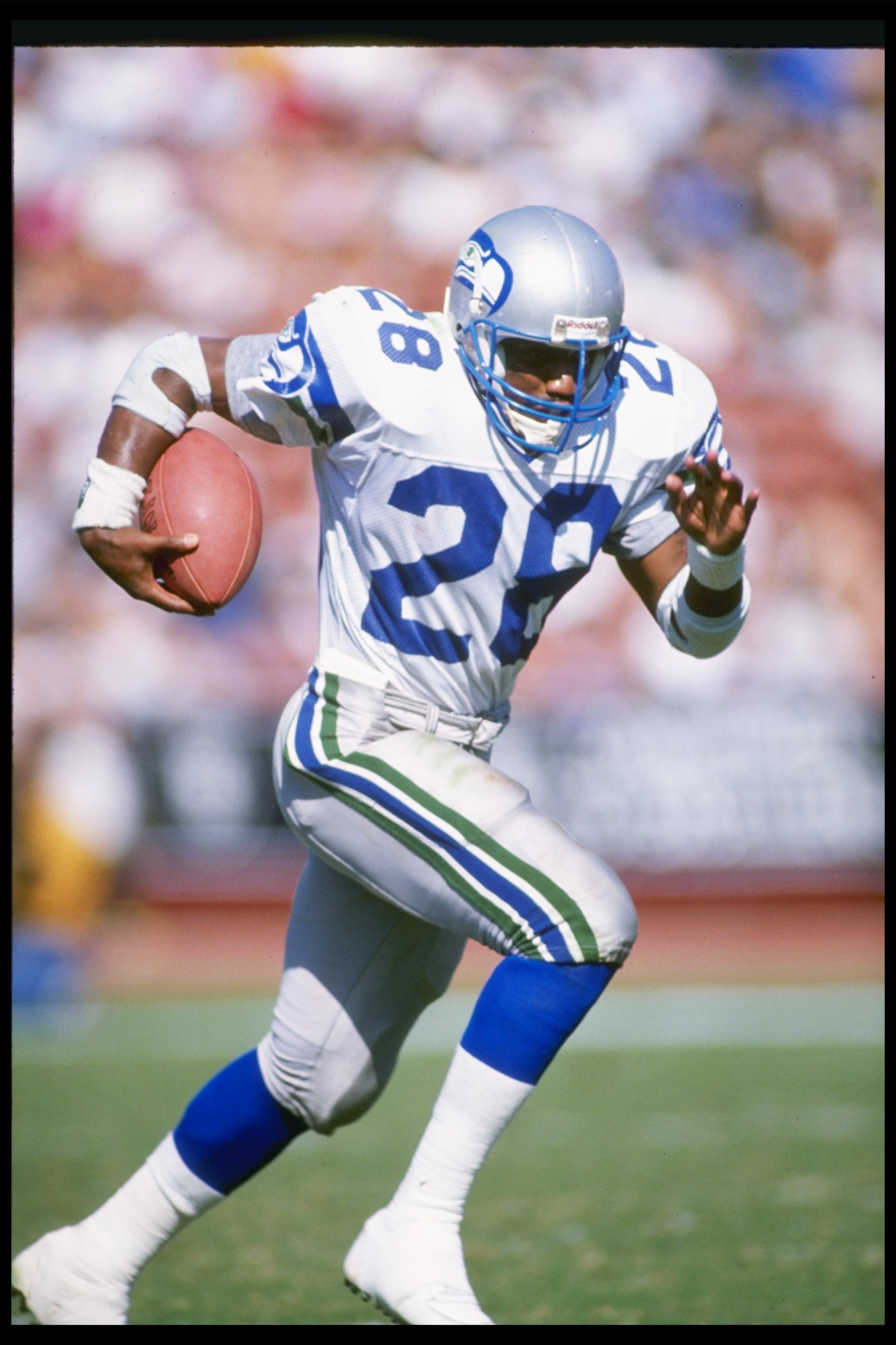 Running back Curt Warner of the Seattle Seahawks moves the ball during a game against the Los Angeles Raiders at the Los Angeles Memorial Coliseum in Los Angeles, California. The Seahawks won the game, 24-20.