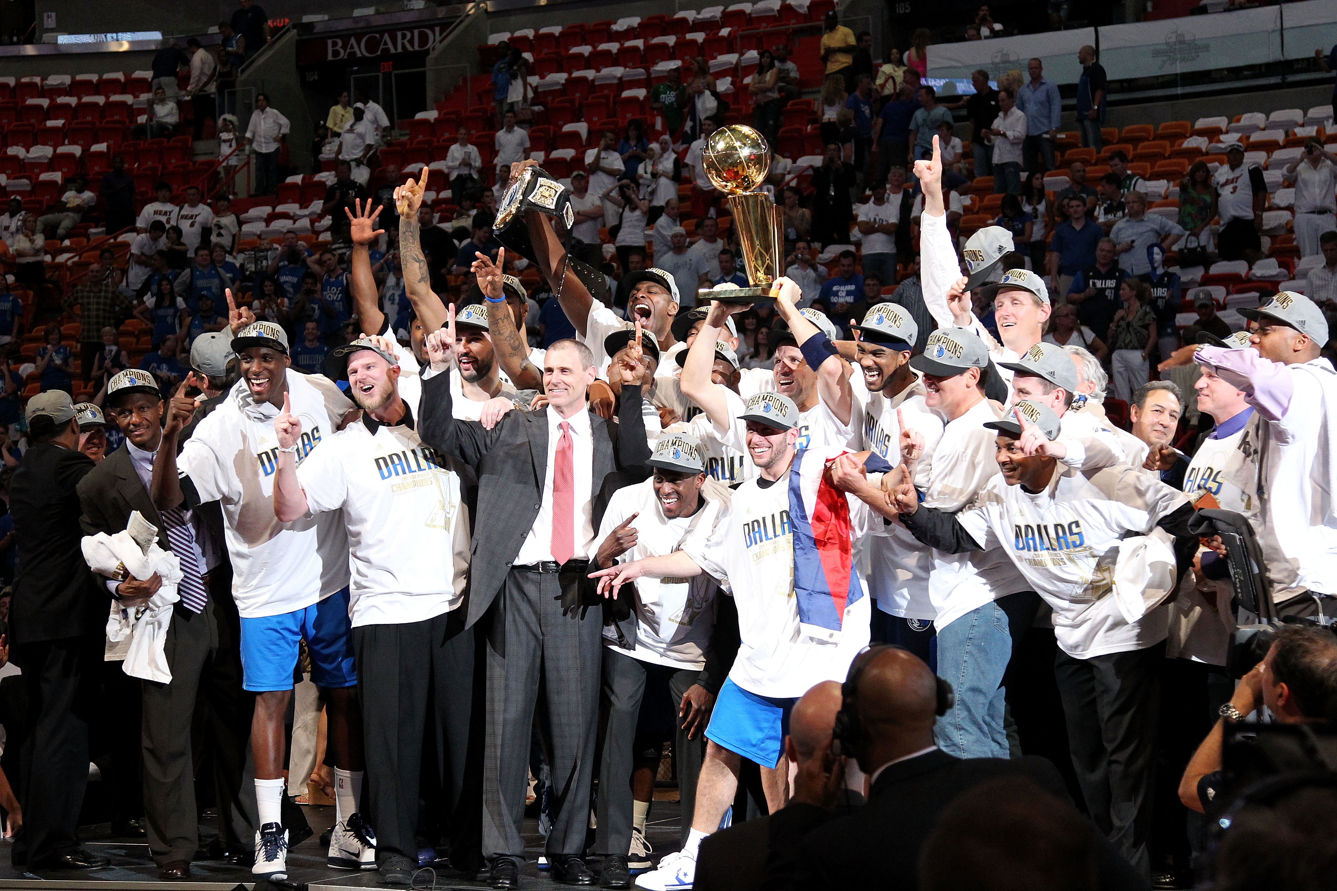 MIAMI, FL - JUNE 12:  Jason Kidd #2 of the Dallas Mavericks holds up the Larry O'Brien Championship trophy as he celebrates with his teammates, head coach Rick Carlisle and team owner Mark Cuban after they won 105-95 against the Miami Heat in Game Six of