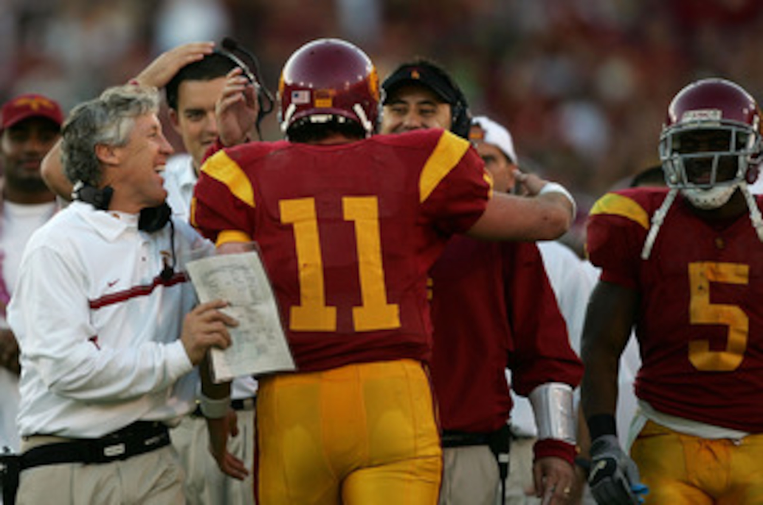 LOS ANGELES, CA - DECEMBER 03: Matt Leinart #11 of the USC Trojans celebrates with USC head coach Pete Carroll and other assistant coaches after USC scored a touchdown to take a 52-6 lead in the third quarter against the UCLA Bruins December 3, 2005 at t LOS ANGELES, CA - DECEMBER 03: Matt Leinart #11 of the USC Trojans celebrates with USC head coach Pete Carroll and other assistant coaches after USC scored a touchdown to take a 52-6 lead in the third quarter against the UCLA Bruins December 3, 2005 at t