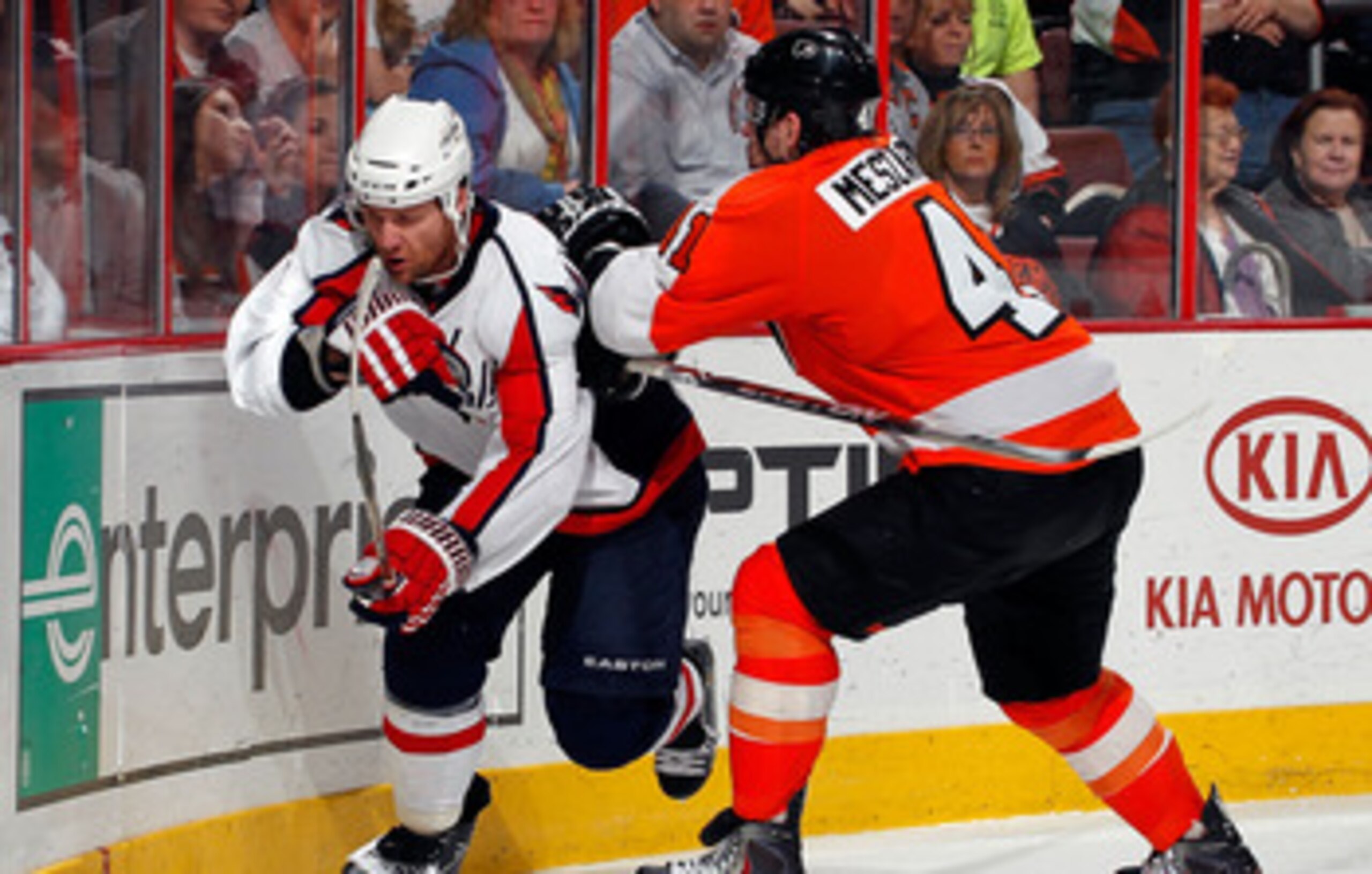 PHILADELPHIA, PA - MARCH 22:  Dennis Wideman #6 of the Washington Capitals is checked by Andrej Meszaros #41 of the Philadelphia Flyers during an NHL hockey game at the Wells Fargo Center on March 22, 2011 in Philadelphia, Pennsylvania.  (Photo by Paul Be