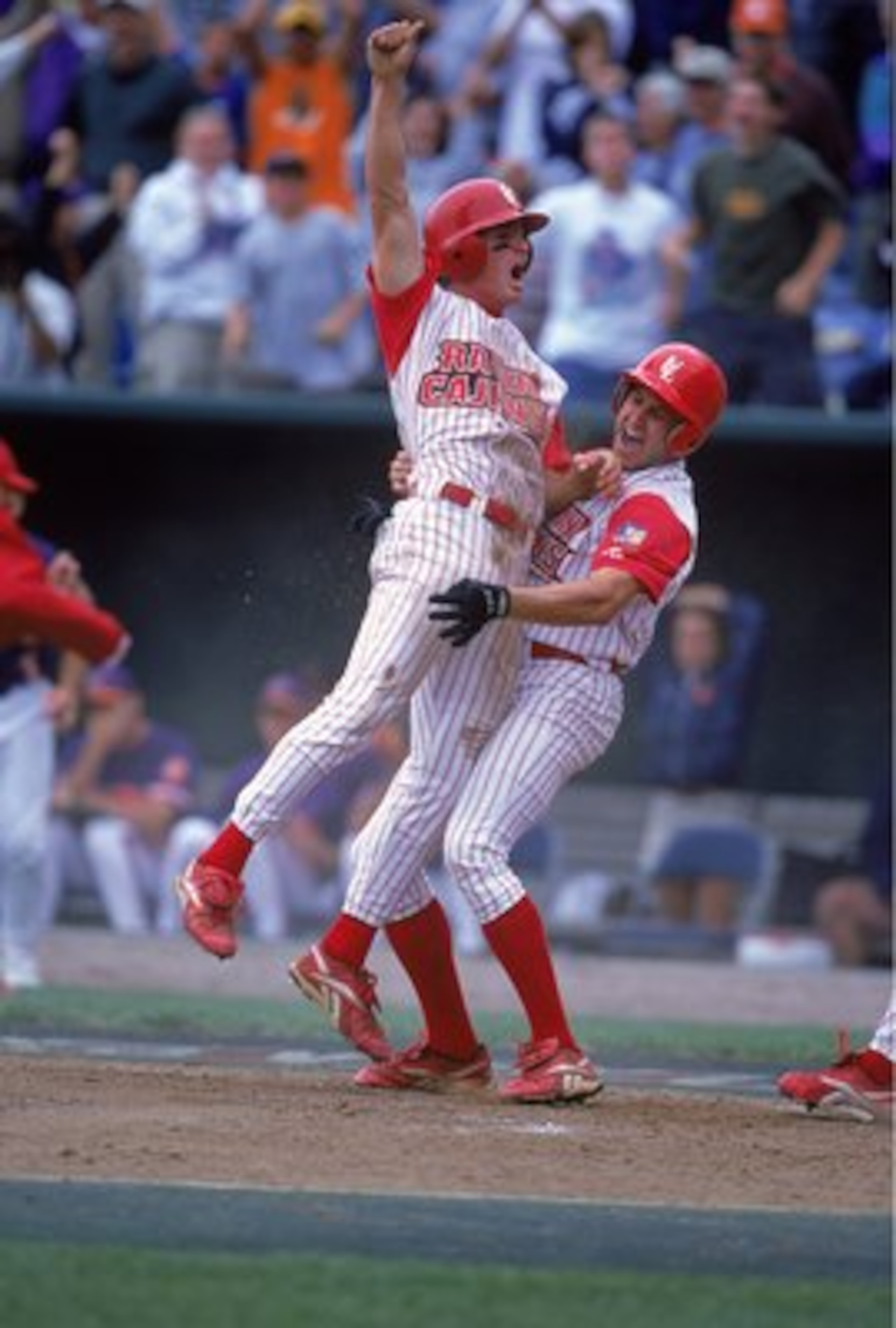 14 Jun 2000:  Steven Feehan #34 of the Louisiana Lafayette Ragin Cajuns celebrates with his teammates during the College World Series against the Clemson Tigers at the Resenblatt Stadium in Omaha, Nebraska. The Raggin Cajuns defeated the Tigers 6-3. Manda