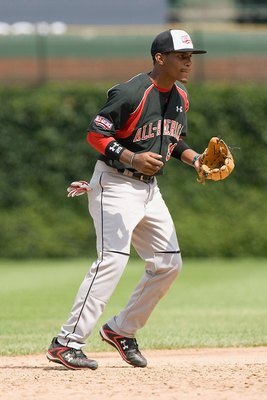 CHICAGO, IL - AUGUST 17: Mychal Givens #29 of the Baseball Factory team moves against the Team One team (red jersey) during the Under Armour All-America Baseball Game at Wrigley Field on August 17, 2008 in Chicago, Illinois.  (Photo by Dilip Vishwanat/Get