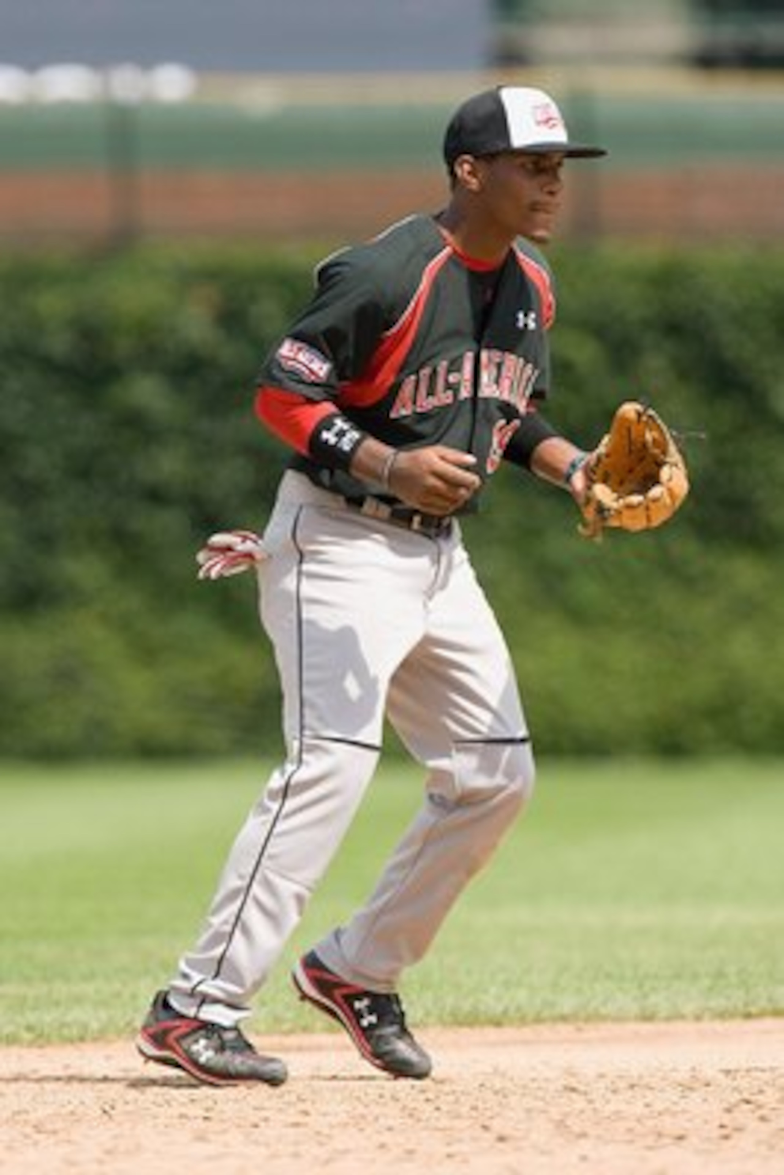 CHICAGO, IL - AUGUST 17: Mychal Givens #29 of the Baseball Factory team moves against the Team One team (red jersey) during the Under Armour All-America Baseball Game at Wrigley Field on August 17, 2008 in Chicago, Illinois.  (Photo by Dilip Vishwanat/Get