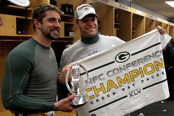 CHICAGO, IL - JANUARY 23:  (L-R) Quarterback Aaron Rodgers #12 and Matt Flynn #10 of the Green Bay Packers celebrate the Packers 21-14 victory against the Chicago Bears with the George Halas Trophy after the NFC Championship Game at Soldier Field on Janua