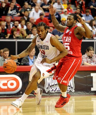 LAS VEGAS, NV - MARCH 10:  Kawhi Leonard #15 of the San Diego State Aztecs drives against Josh Watkins #15 of the Utah Utes during a quarterfinal game of the Conoco Mountain West Conference Basketball tournament at the Thomas & Mack Center March 10, 2011