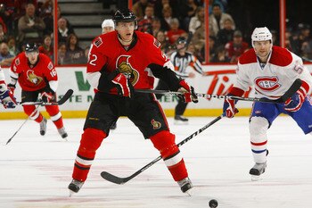 OTTAWA, CANADA - APRIL 07:  Colin Greening #52 of the Ottawa Senators chases a loose puck while being pursued by Mathieu Darche #52 of the Montreal Canadiens in a game at Scotiabank Place on April 7, 2011 in Ottawa, Canada.  (Photo by Phillip MacCallum/Ge