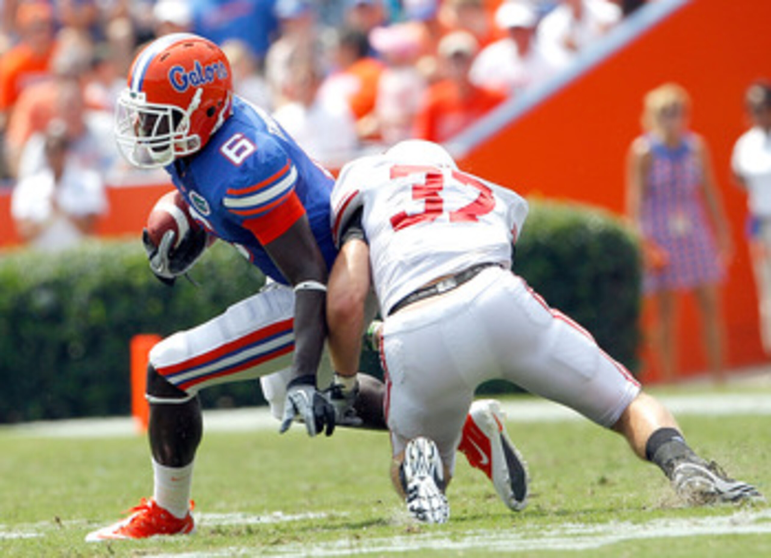 GAINESVILLE, FL - SEPTEMBER 04:  Pat Hinkel #37 of the Miami University RedHawks attempts to tackle Deonte Thompson #6 of the Florida Gators at Ben Hill Griffin Stadium on September 4, 2010 in Gainesville, Florida.  (Photo by Sam Greenwood/Getty Images)