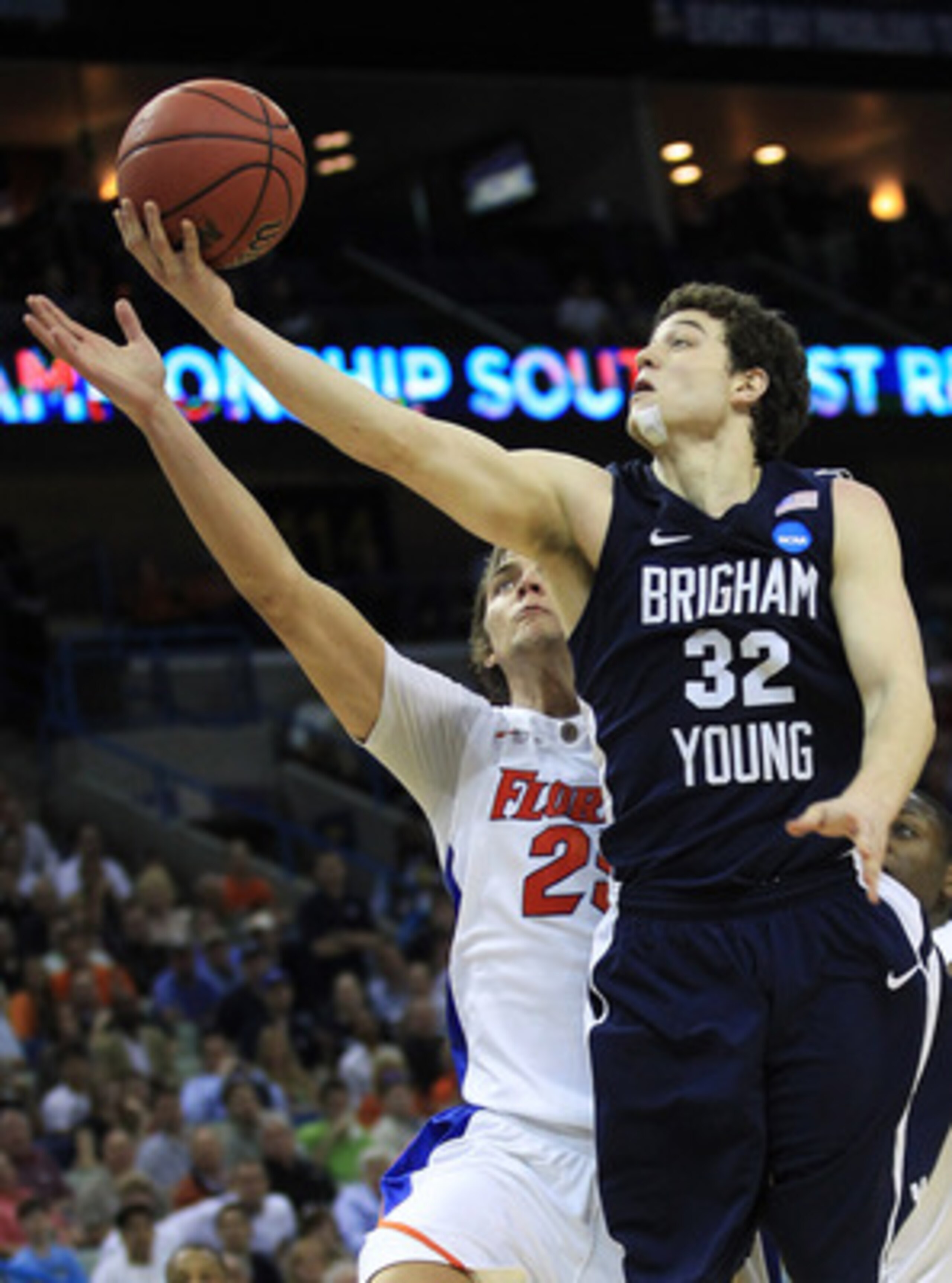 NEW ORLEANS, LA - MARCH 24:  Jimmer Fredette #32 of the Brigham Young Cougars shoots over Chandler Parsons #25 of the Florida Gators in the second half during the Southeast regional of the 2011 NCAA men's basketball tournament at New Orleans Arena on Marc