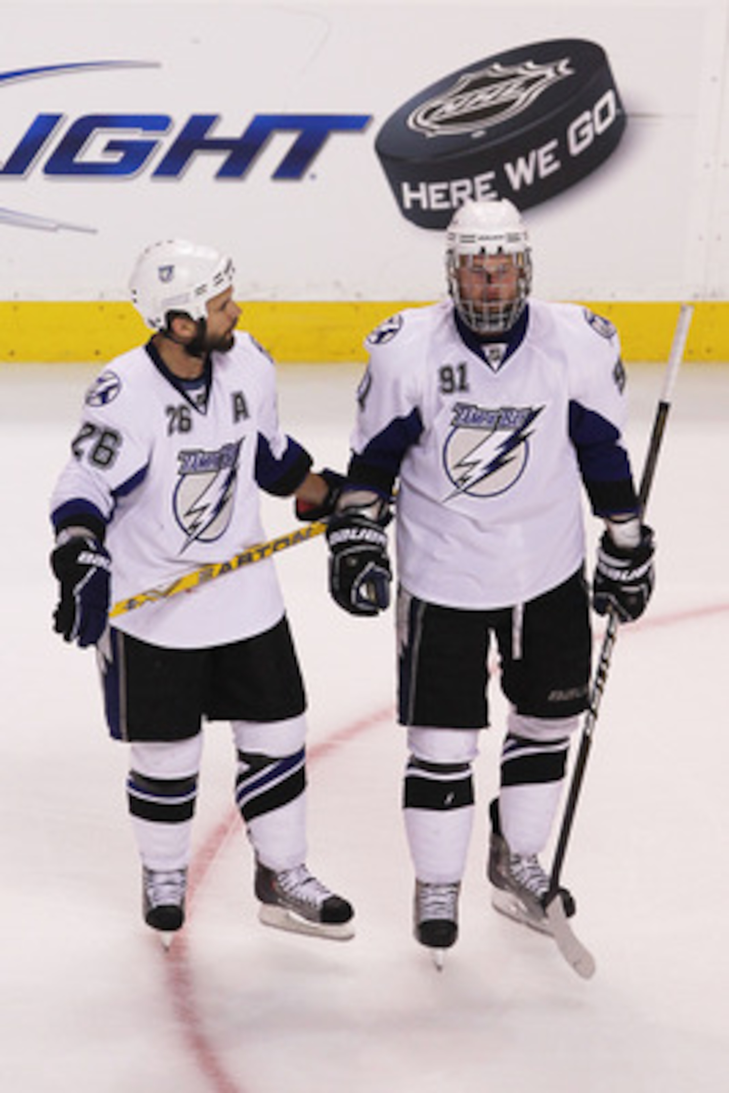 BOSTON, MA - MAY 27:  Martin St. Louis #26 talks to Steven Stamkos #91 of the Tampa Bay Lightning upon Stamkos' returned to the game after being hhit in the face with a puck in Game Seven of the Eastern Conference Finals against the Boston Bruins during t