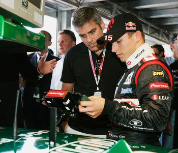 MONTE CARLO, MONACO -  MAY 22:  Christian Klien shows George Clooney, the official guests of Jaguar Racing, the steering wheel of his Jaguar R5 in the garage after practice for the Monaco F1 Grand Prix on May 22, 2004, in Monte Carlo, Monaco. (Photo by Ma