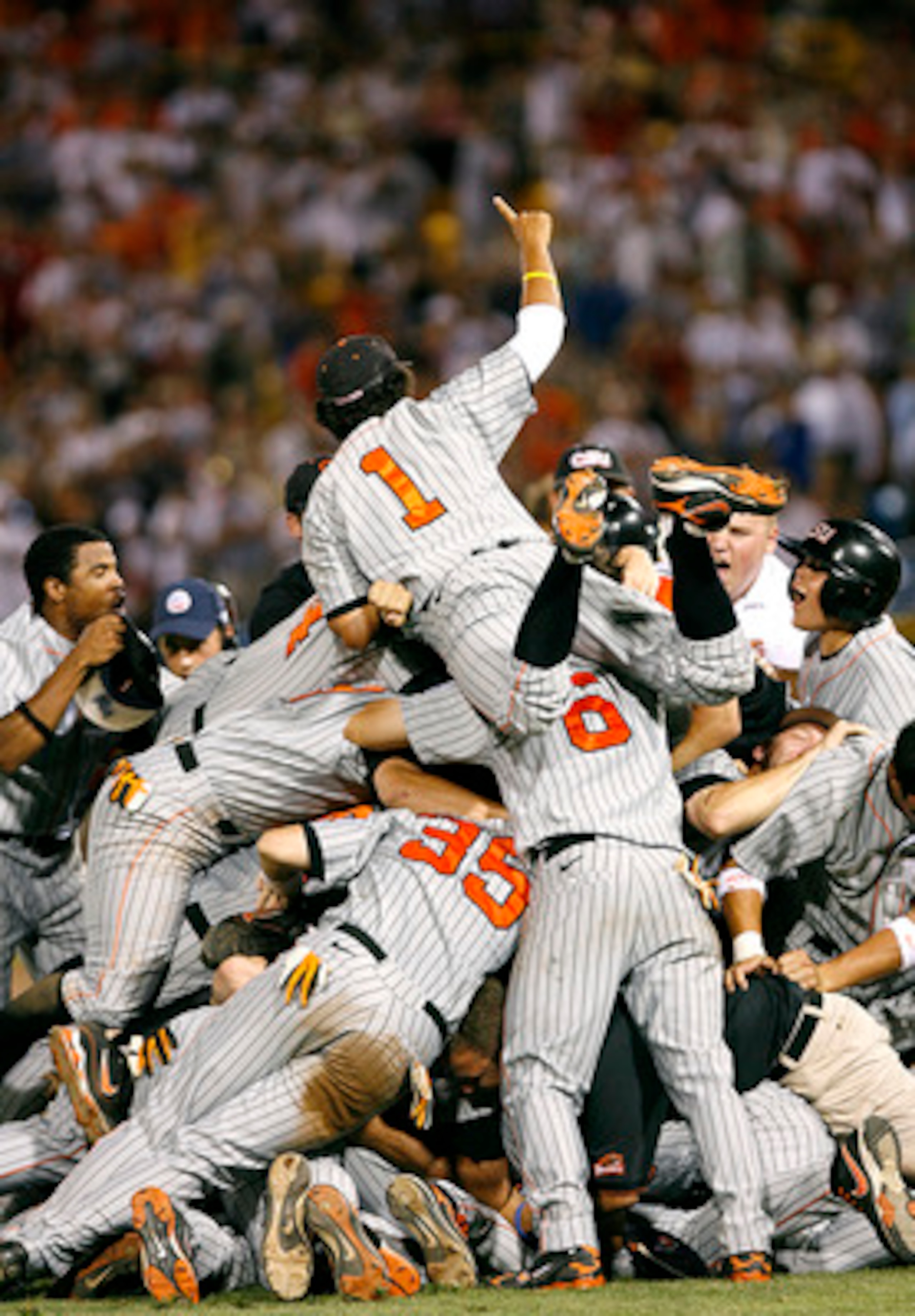 OMAHA, NE - JUNE 24:  Joey Wong #1 of the Oregon State Beavers leaps on top of the pile as his team celebrates winning their second straight NCAA Championship after defeating the North Carolina Tar Heels 9-3 in Game 2 of the NCAA College World Series Cham