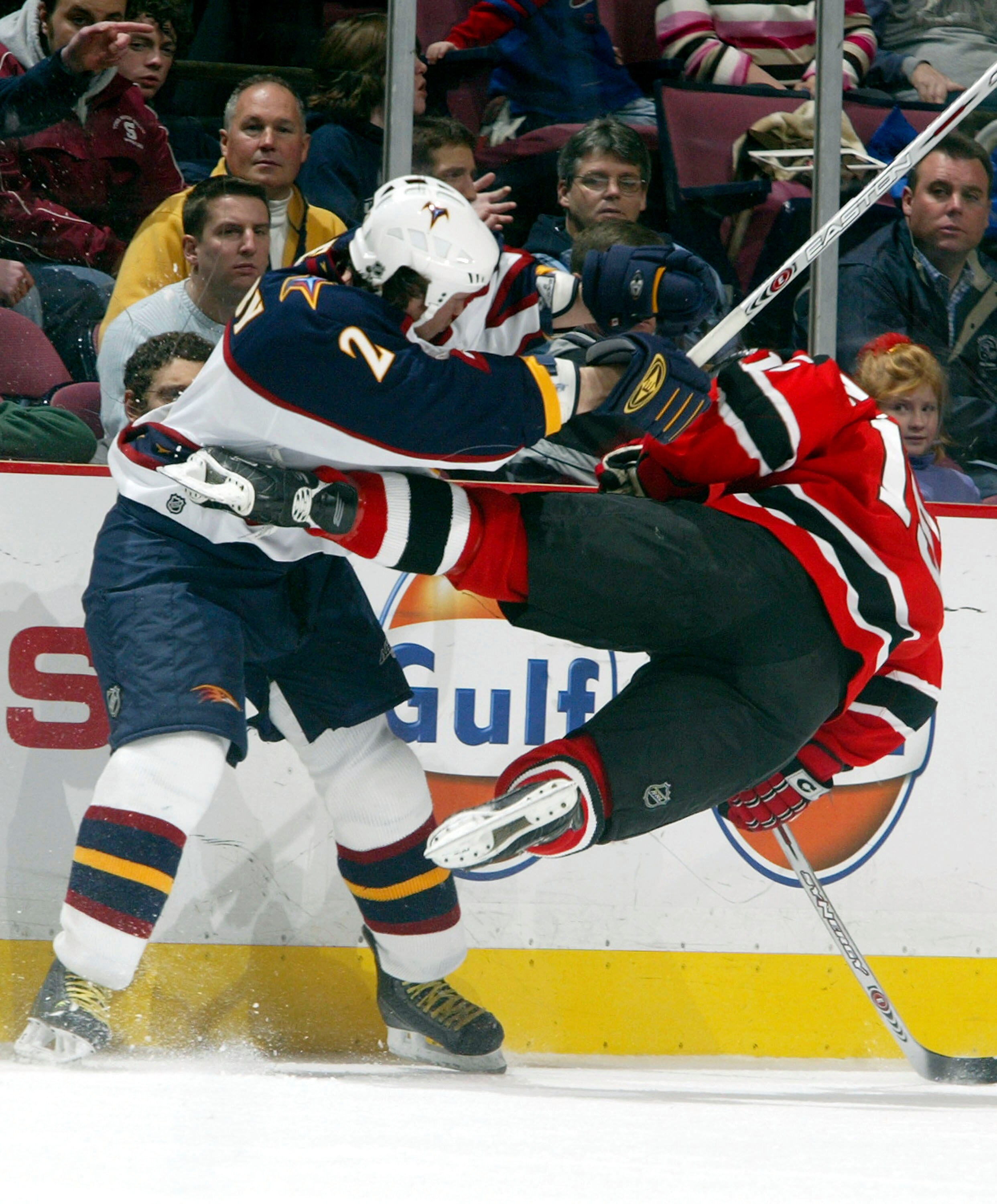 EAST RUTHERFORD, NJ - DECEMBER 23:   Defenseman Garnet Exelby #2 of the Atlanta Thrashers knocks down Jamie Langenbrunner #15 of the New Jersey Devils during their game at the Continental Airlines Arena on December 23, 2005 in East Rutherford, New Jersey.
