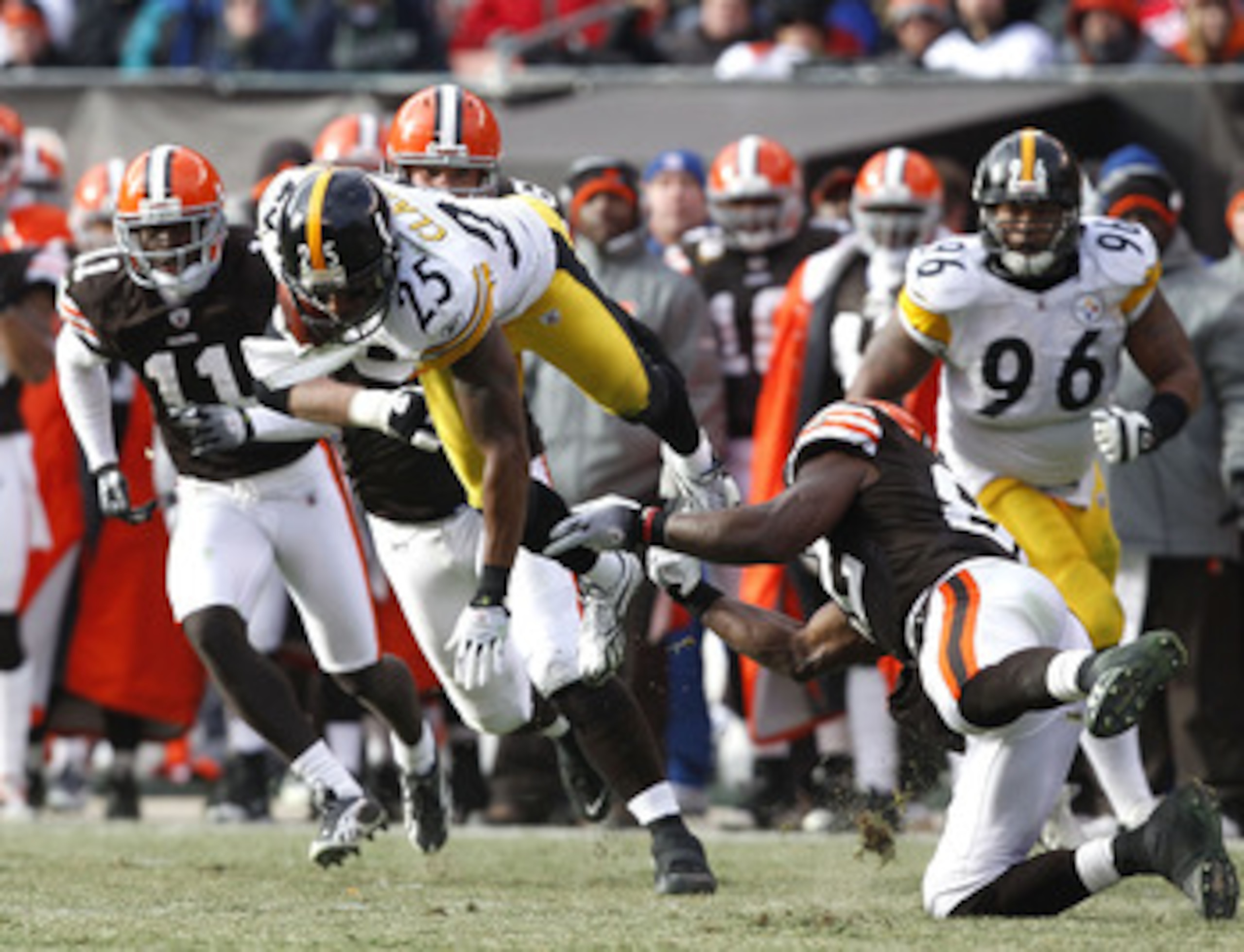 CLEVELAND, OH - JANUARY 02:  Safety Ryan Clark #25 of the Pittsburgh Steelers returns an interception as he is hit by tight end Benjamin Watson #82 of the Cleveland Browns at Cleveland Browns Stadium on January 2, 2011 in Cleveland, Ohio.  (Photo by Matt 