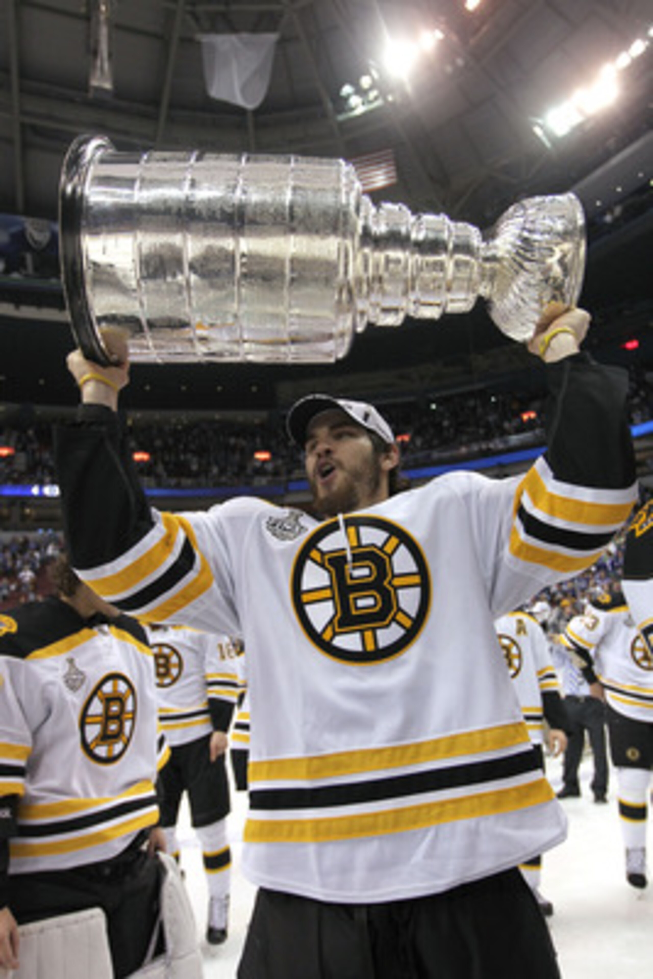 VANCOUVER, BC - JUNE 15:  Adam McQuaid #54 of the Boston Bruins celebrates as he lifts the Stanley Cup after defeating the Vancouver Canucks in Game Seven of the 2011 NHL Stanley Cup Final at Rogers Arena on June 15, 2011 in Vancouver, British Columbia, C