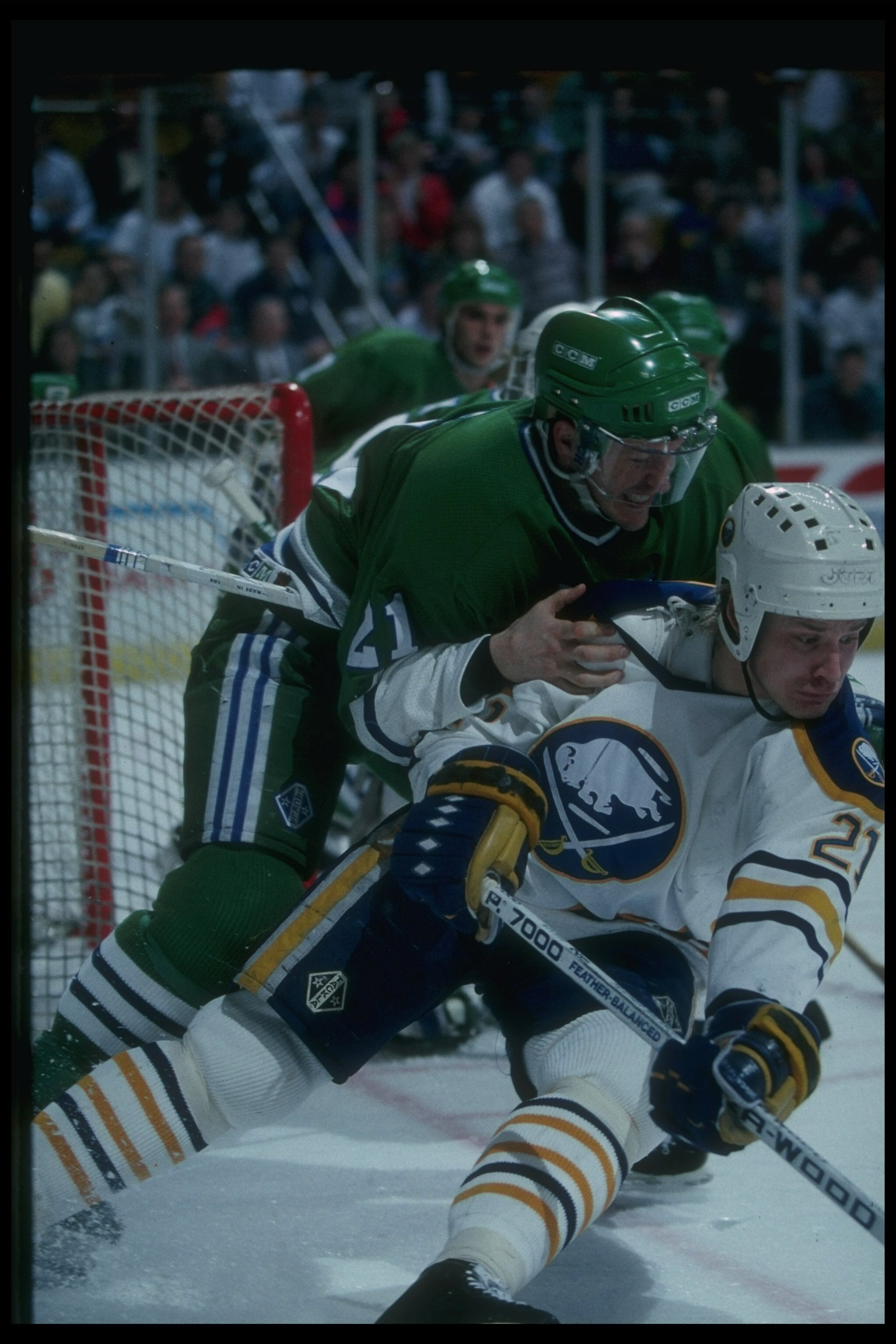 Christian Ruuttu of the Buffalo Sabres is checked by a member of the Hartford Whalers at the Memorial Auditorium in Buffalo, New York.
