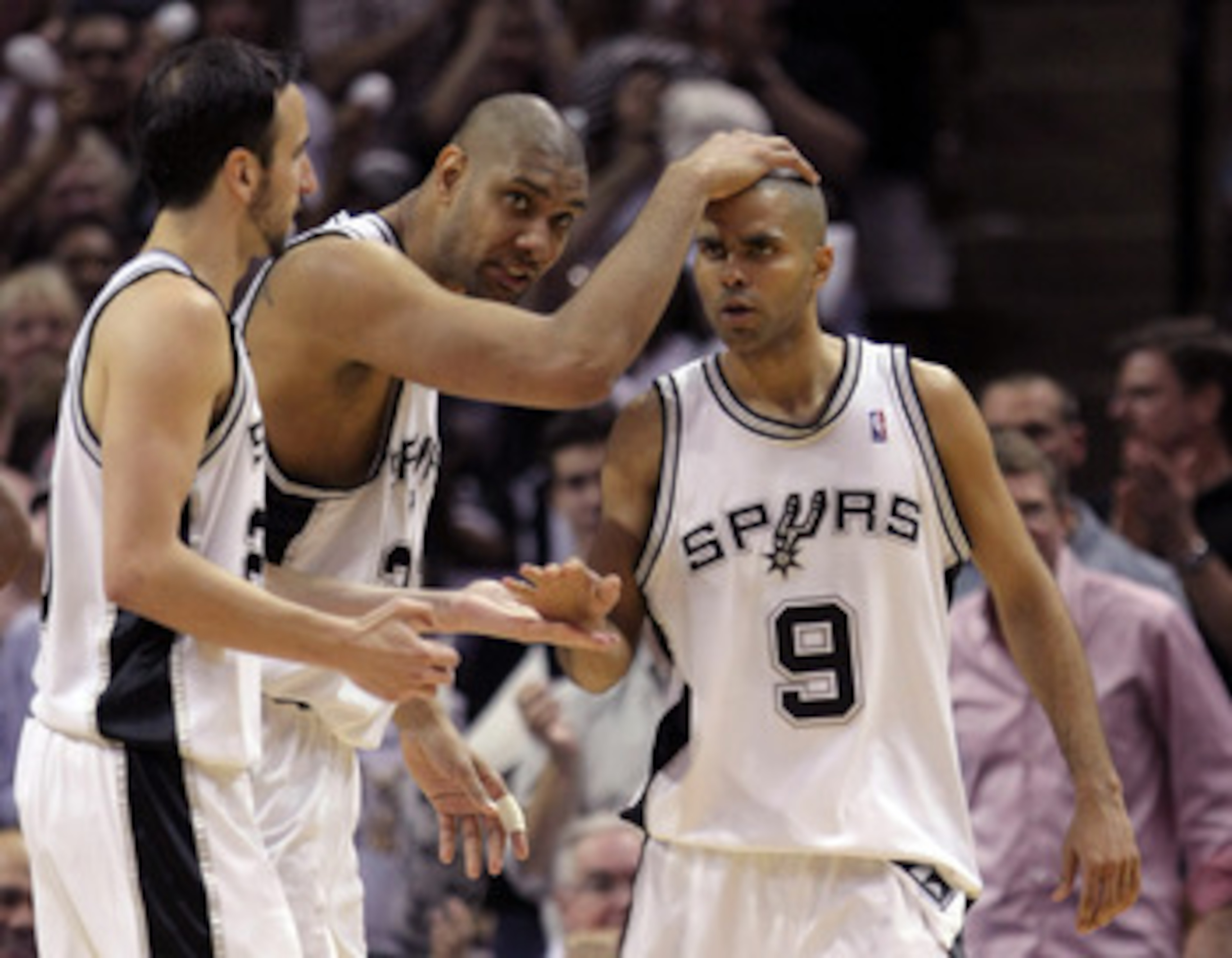 SAN ANTONIO - APRIL 29:  Tony Parker #9 of the San Antonio Spurs celebrates his basket in the final seconds of the first half with Tim Duncan #21 and  Manu Ginobili #20 against the Phoenix Suns in Game Five of the Western Conference Quarterfinals during t
