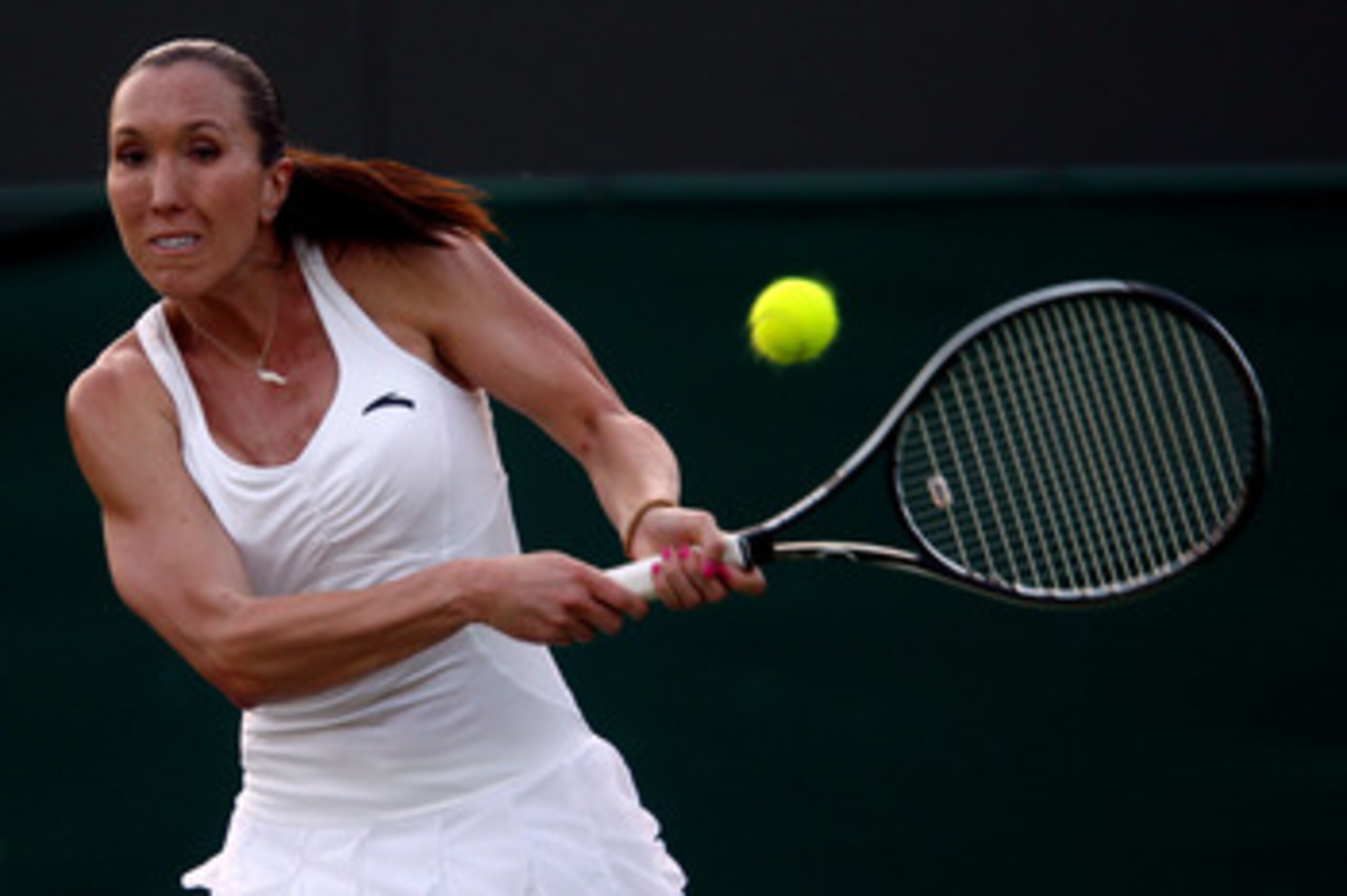 LONDON, ENGLAND - JUNE 23:  Jelena Jankovic of Serbia returns a shot during her second round match against Aleksandra Wozniak of Canada on Day Three of the Wimbledon Lawn Tennis Championships at the All England Lawn Tennis and Croquet Club on June 23, 201