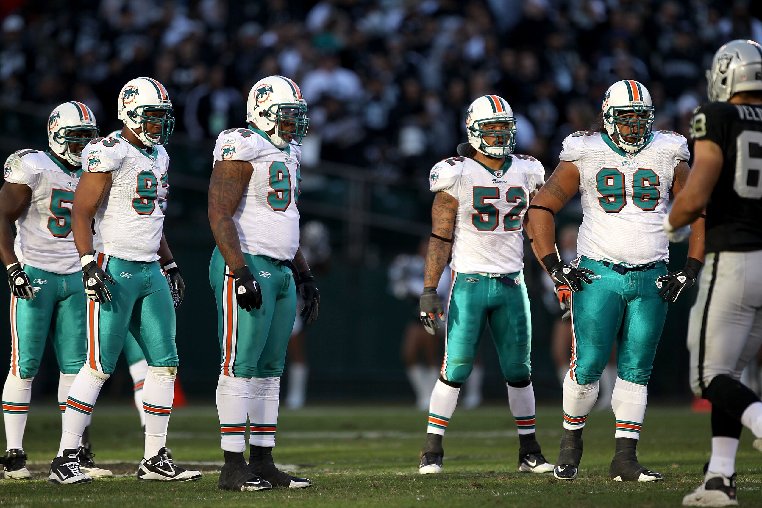 OAKLAND, CA - NOVEMBER 28:  Tim Dobbins #51, Quentin Moses #93, Randy Starks #94, Channing Crowder #52 and Paul Soliai #96 of the Miami Dolphins get ready for a play against the Oakland Raiders at Oakland-Alameda County Coliseum on November 28, 2010 in Oa