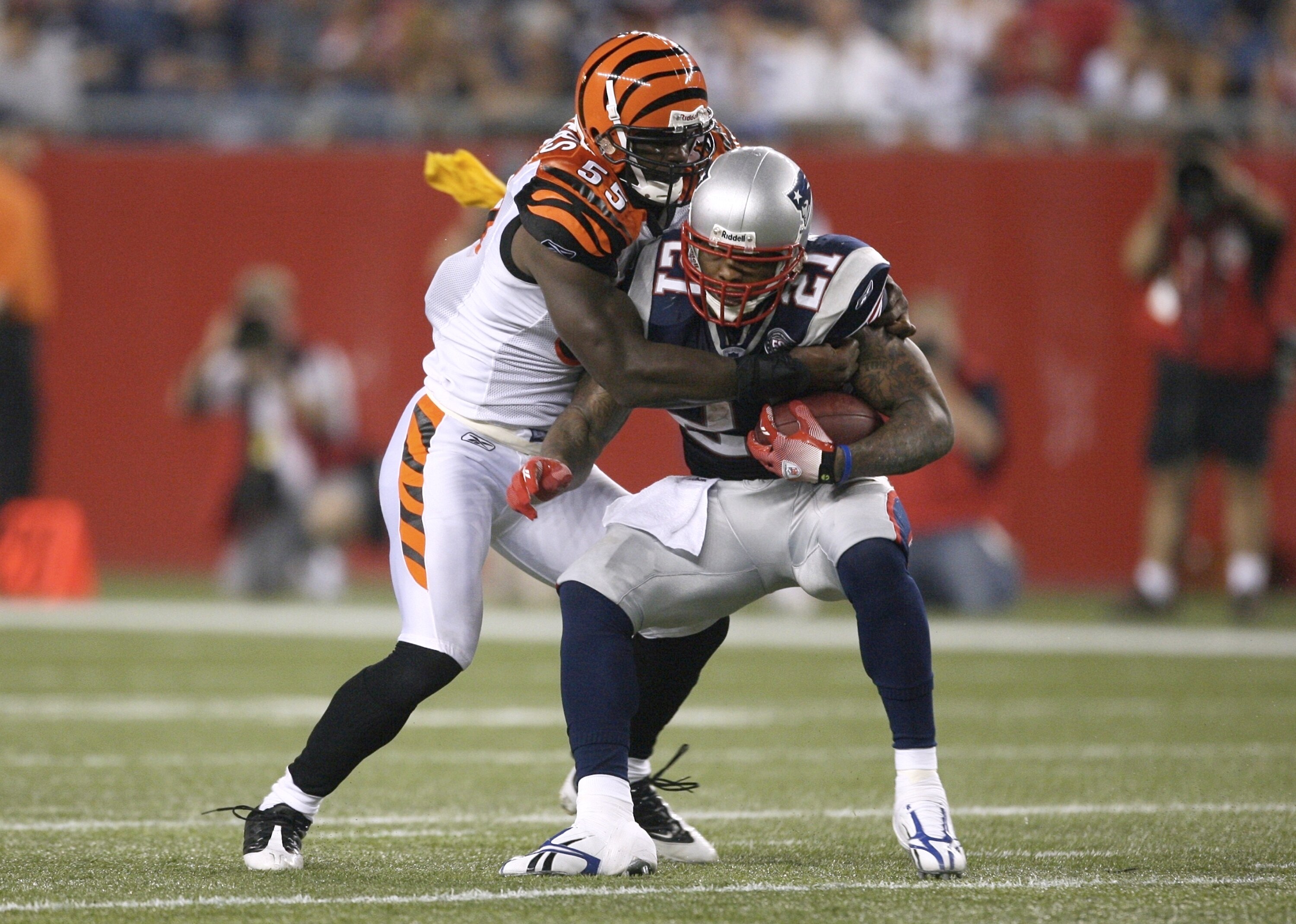 FOXBORO, MA - AUGUST 20:  Fred Taylor #21 of the New England Patriots runs the ball against Keith Rivers #55 of the Cincinnati Bengals during their preseason game at Gillette Stadium on August 20, 2009 in Foxboro, Massachusetts. A flag is thrown by a refe