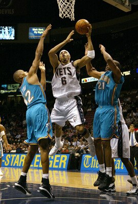 EAST RUTHERFORD, NJ - NOVEMBER 18: Kenyon Martin #6 of the New Jersey Nets shoots over Jamaal Magloire #21 and P.J. Brown #42 of the New Orleans Hornets on November 18, 2003 at Continental Airlines Arena in East Rutherford, New Jersey. NOTE TO USER: Us EAST RUTHERFORD, NJ - NOVEMBER 18: Kenyon Martin #6 of the New Jersey Nets shoots over Jamaal Magloire #21 and P.J. Brown #42 of the New Orleans Hornets on November 18, 2003 at Continental Airlines Arena in East Rutherford, New Jersey. NOTE TO USER: Us