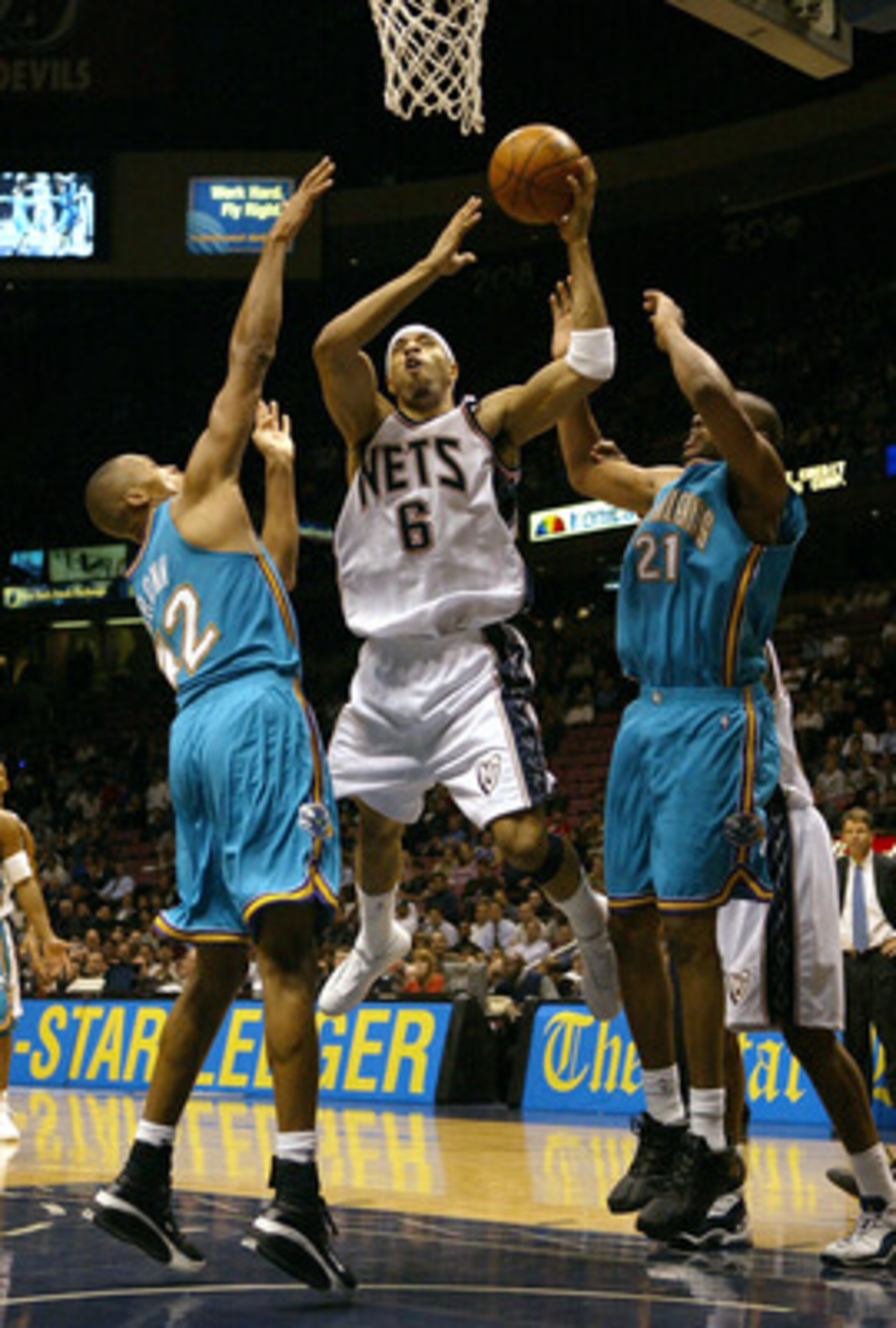 EAST RUTHERFORD, NJ - NOVEMBER 18:  Kenyon Martin #6 of the New Jersey Nets shoots over Jamaal Magloire #21 and P.J. Brown #42 of the New Orleans Hornets on November 18, 2003 at Continental Airlines Arena in East Rutherford, New Jersey.   NOTE TO USER: Us