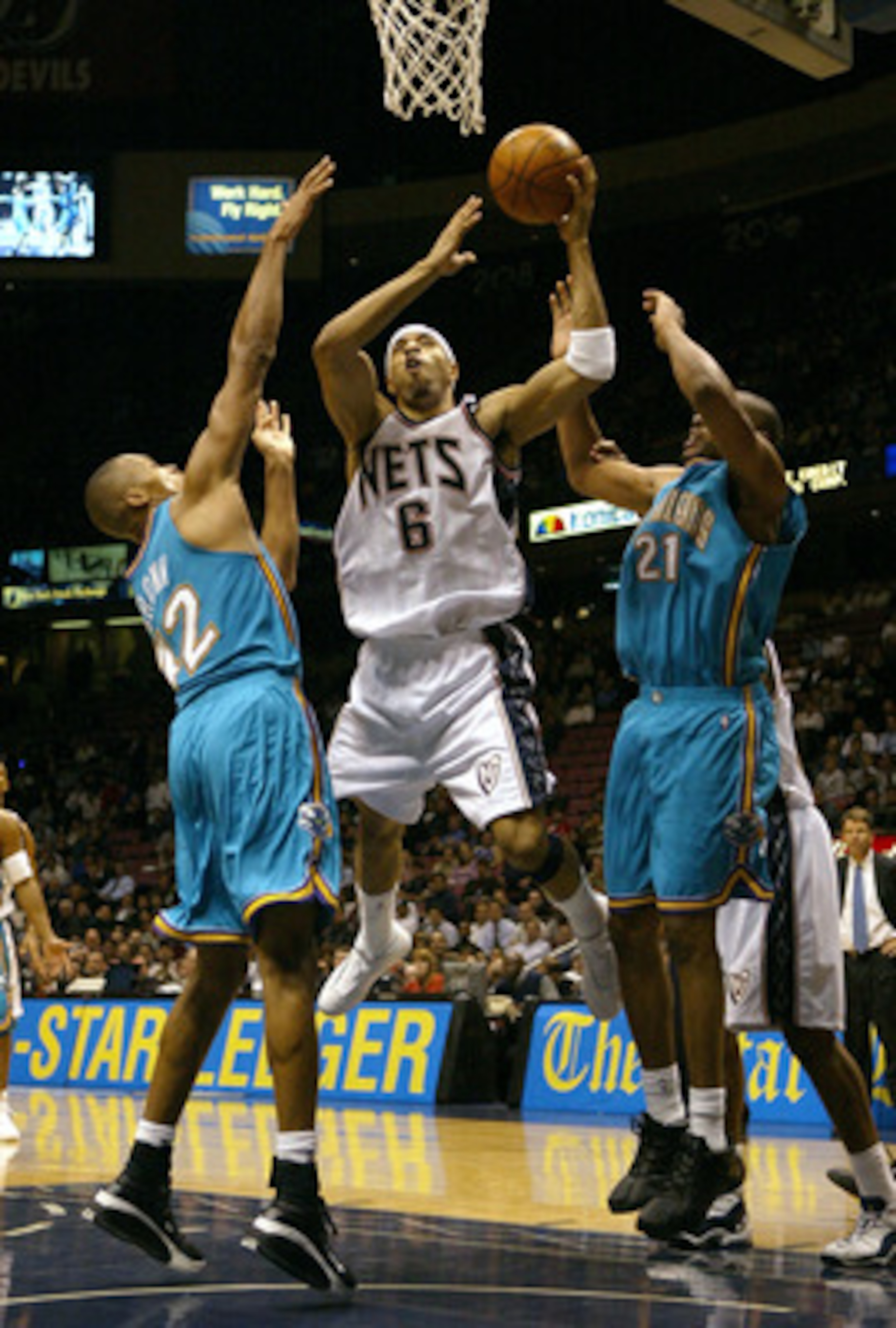 EAST RUTHERFORD, NJ - NOVEMBER 18:  Kenyon Martin #6 of the New Jersey Nets shoots over Jamaal Magloire #21 and P.J. Brown #42 of the New Orleans Hornets on November 18, 2003 at Continental Airlines Arena in East Rutherford, New Jersey.   NOTE TO USER: Us