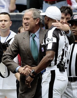 HOUSTON - OCTOBER 25:  Former President George W. Bush gives NFL referee Mike Carey a hug before the Houston Texans and Sa Francisco 49ers at Reliant Stadium on October 25, 2009 in Houston, Texas.  (Photo by Bob Levey/Getty Images)
