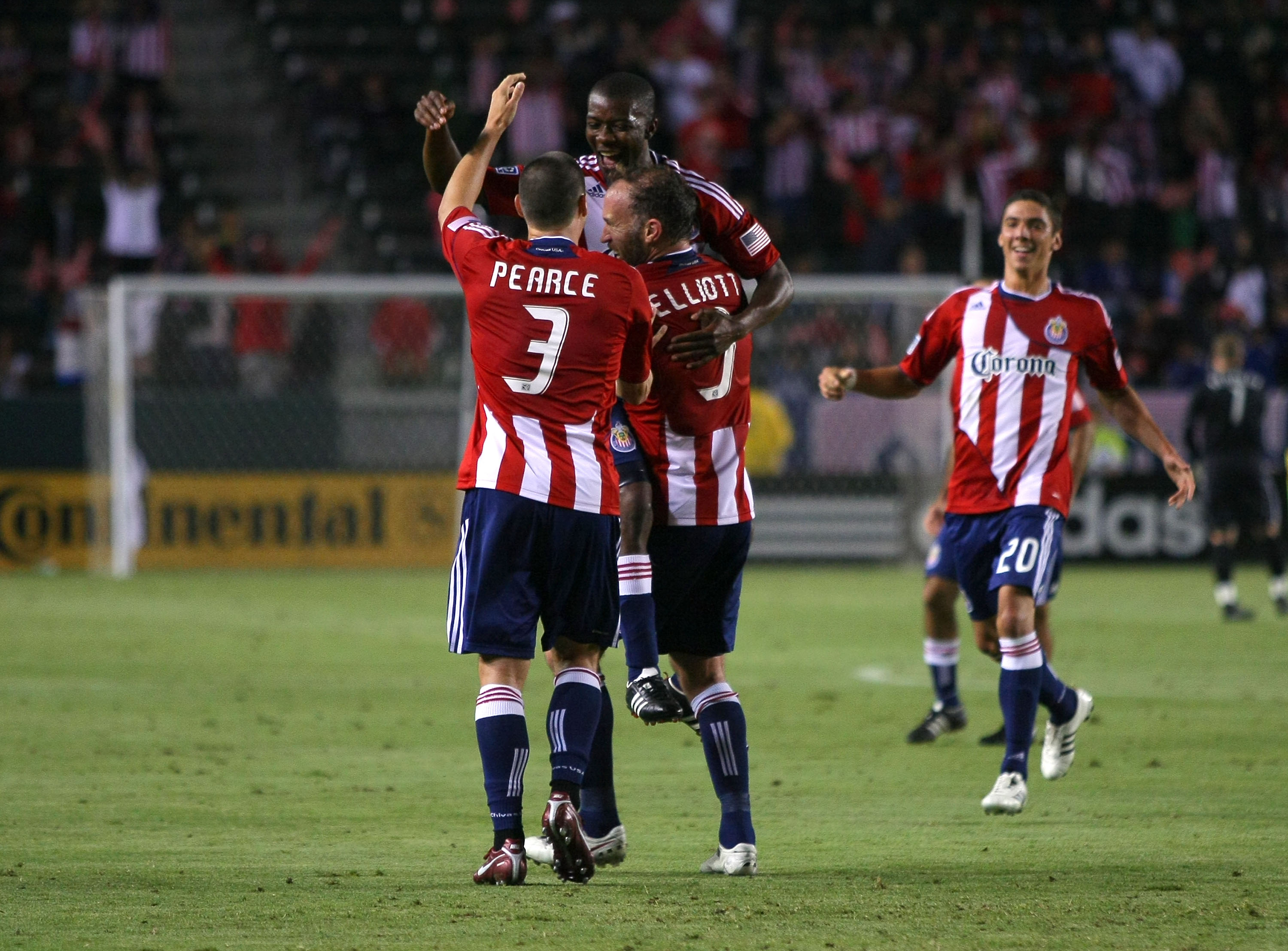 CARSON, CA - JUNE 18:  Heath Pearce #3 and Simon Elliott #9 of Chivas USA celebrate with teammate Michael Lahoud #11 after Lahoud's goal in the second half as teammate Zarek Valentin #20 joins the celebration during their MLS match against FC Dallas at Th