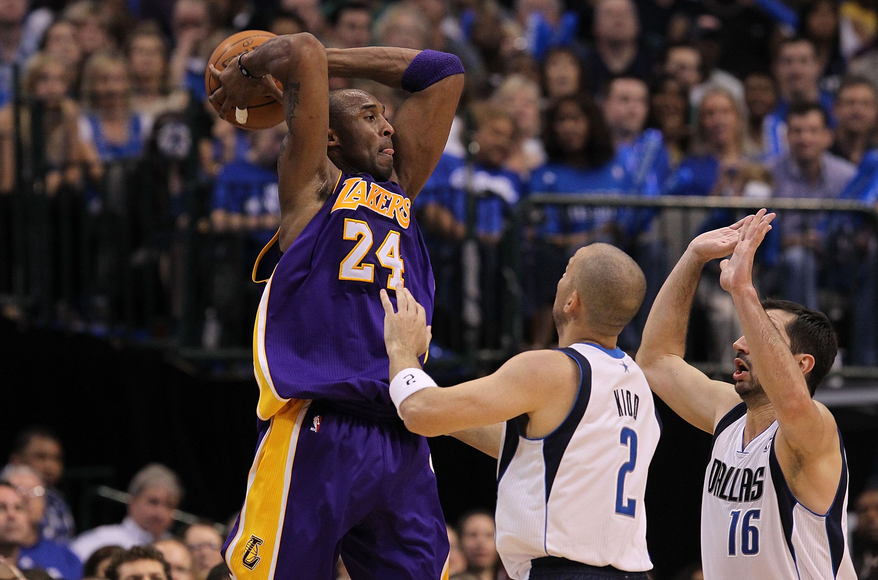 DALLAS, TX - MAY 08:  Guard Kobe Bryant #24 of the Los Angeles Lakers makes a pass against Jason Kidd #2 and Peja Stojakovic #16 of the Dallas Mavericks in Game Four of the Western Conference Semifinals during the 2011 NBA Playoffs on May 8, 2011 at Ameri