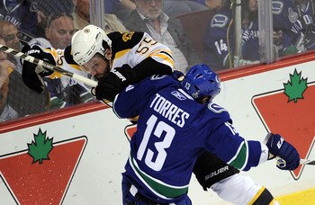 VANCOUVER, BC - JUNE 10:  Johnny Boychuk #55 of the Boston Bruins collides with Raffi Torres #13 of the Vancouver Canucks during Game Five of the 2011 NHL Stanley Cup Final at Rogers Arena on June 10, 2011 in Vancouver, British Columbia, Canada.  (Photo b
