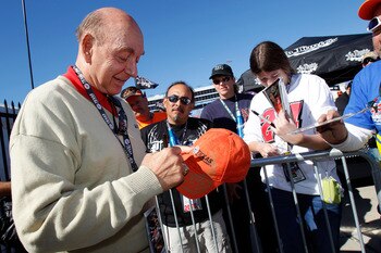 FORT WORTH, TX - NOVEMBER 07:  Sportscaster Dick Vitale (L) signs fans memorabilia prior to the start of the NASCAR Sprint Cup Series AAA Texas 500 at Texas Motor Speedway on November 7, 2010 in Fort Worth, Texas.  (Photo by Todd Warshaw/Getty Images)