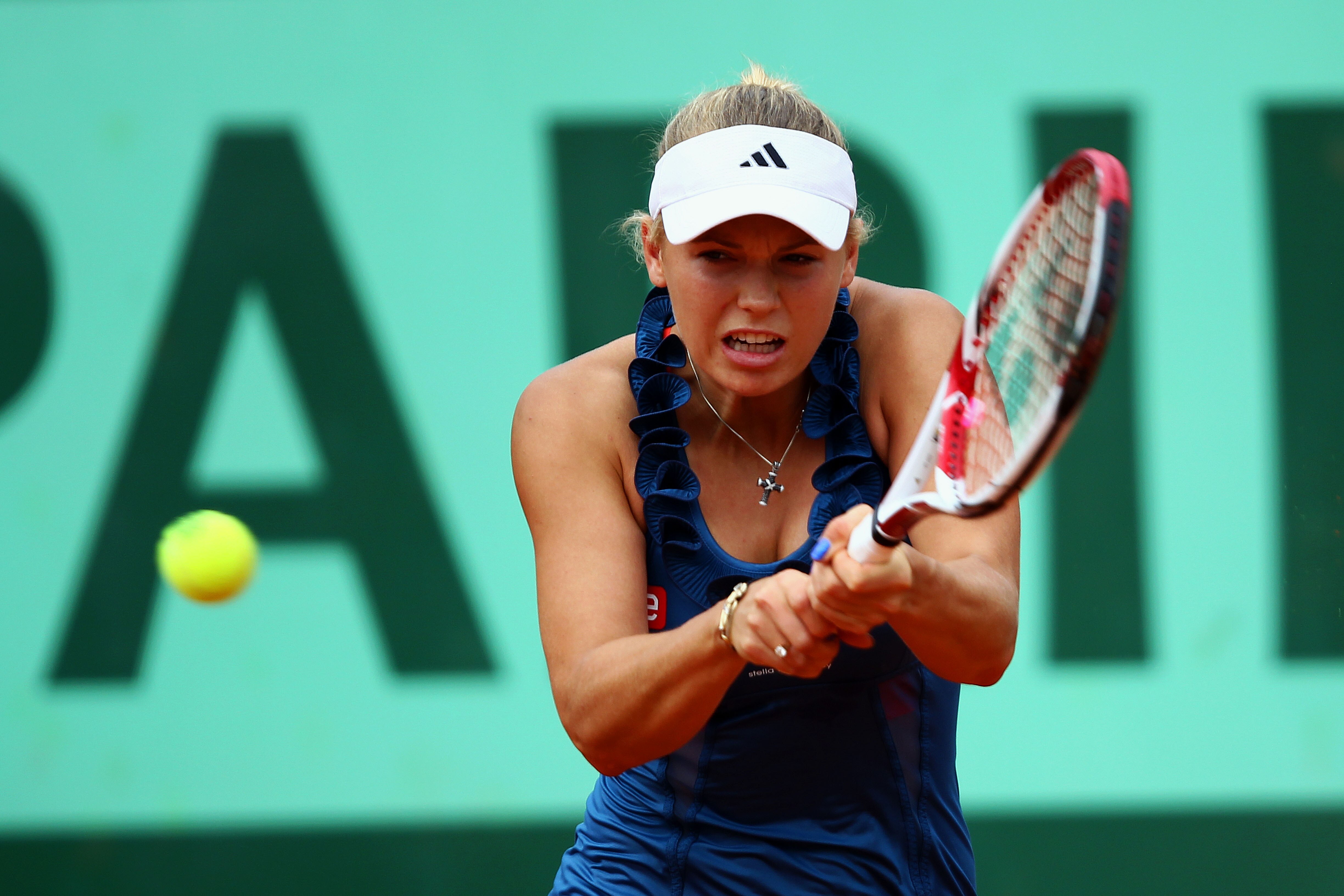 PARIS, FRANCE - MAY 27:  Caroline Wozniacki of Denmark hits a backhand during the women's singles round three match between Caroline Wozniacki of Denmark and Daniela Hantuchova of Slovakia on day six of the French Open at Roland Garros on May 27, 2011 in