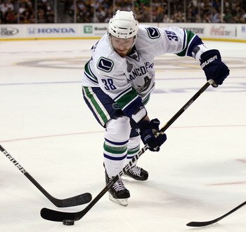 BOSTON, MA - JUNE 13:  Victor Oreskovich #38 of the Vancouver Canucks skates with the puck during Game Six of the 2011 NHL Stanley Cup Final at TD Garden on June 13, 2011 in Boston, Massachusetts.  (Photo by Elsa/Getty Images)
