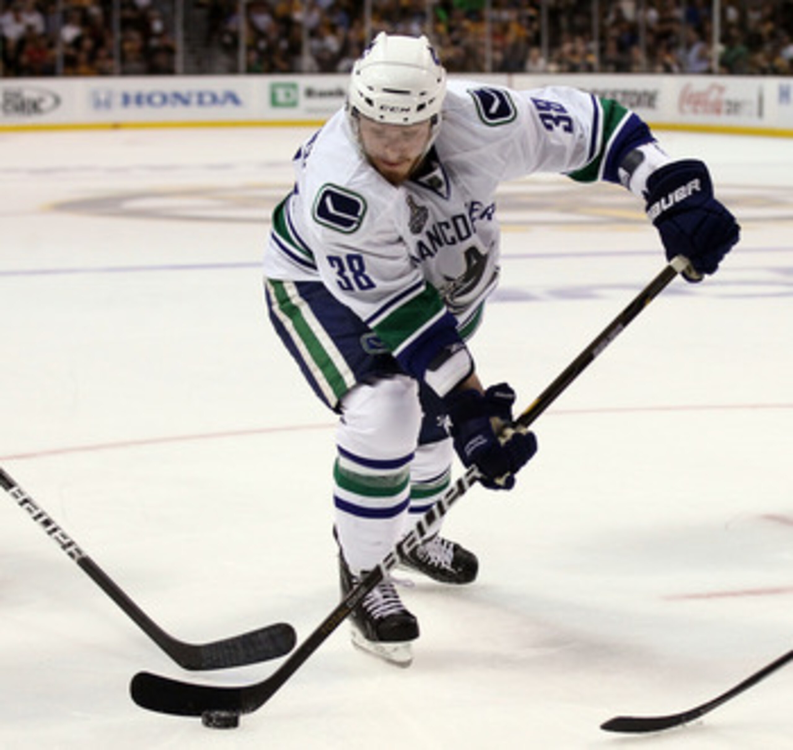 BOSTON, MA - JUNE 13:  Victor Oreskovich #38 of the Vancouver Canucks skates with the puck during Game Six of the 2011 NHL Stanley Cup Final at TD Garden on June 13, 2011 in Boston, Massachusetts.  (Photo by Elsa/Getty Images)