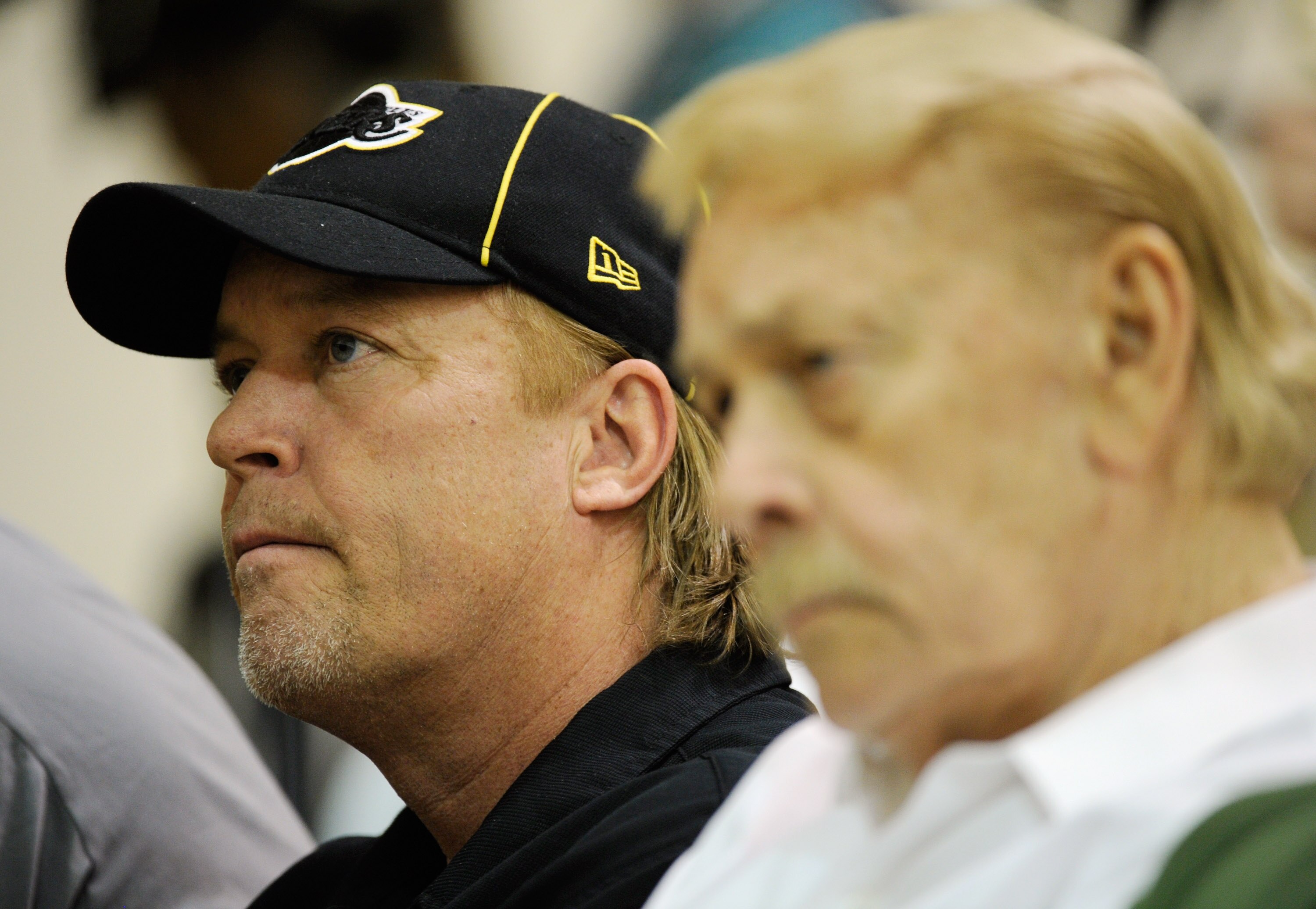 EL SEGUNDO, CA - MAY 31:  Jim Buss, executive vice president of basketball operations of the Los Angeles Lakers, listens to Lakers new coach Mike Brown's speach during his introductory news conference at the team's training facility on May 31, 2011 in El