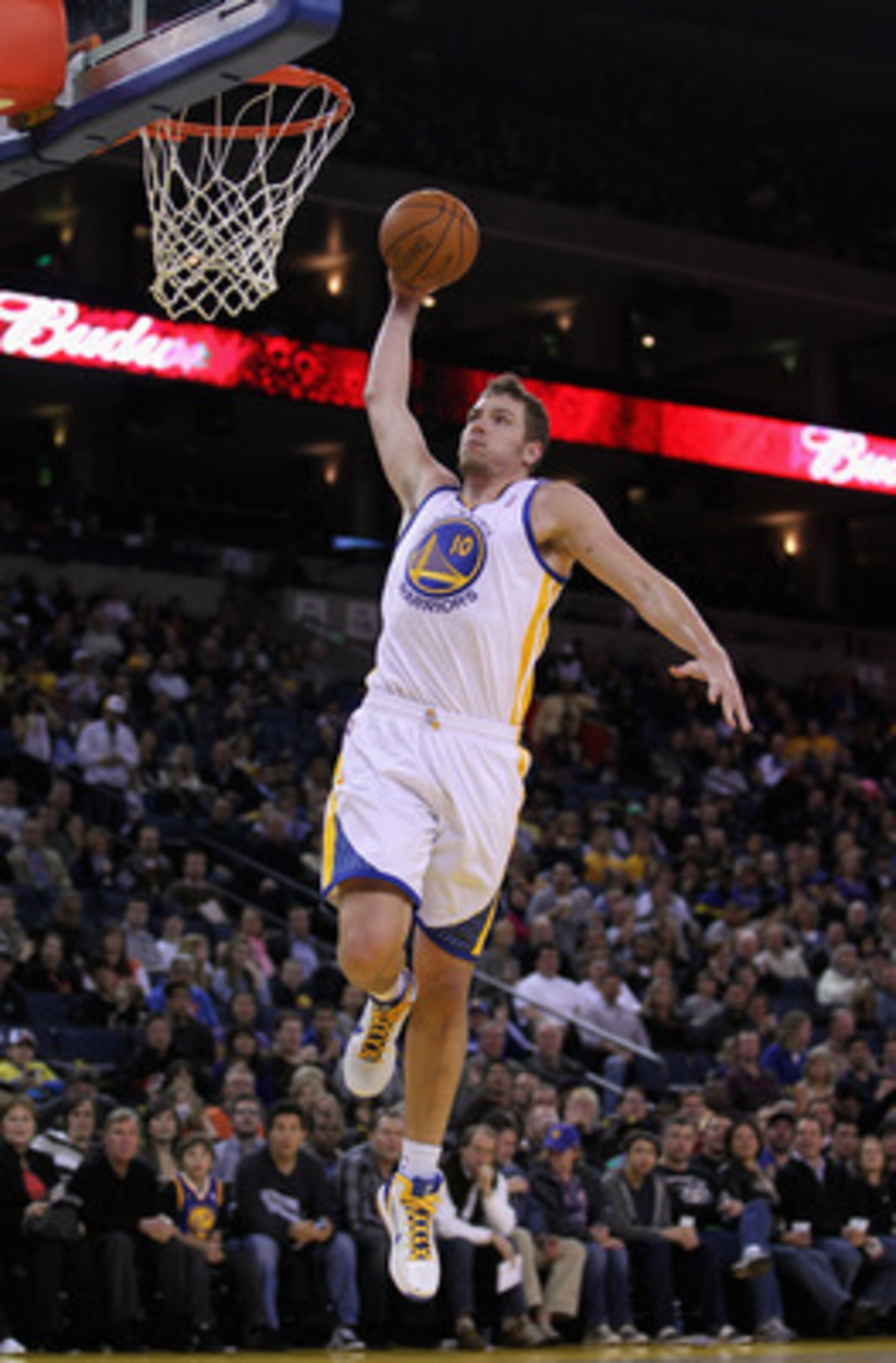 OAKLAND, CA - MARCH 25: David Lee #10 of the Golden State Warriors goes up for a dunk against the Toronto Raptors at Oracle Arena on March 25, 2011 in Oakland, California. NOTE TO USER: User expressly acknowledges and agrees that, by downloading and or us