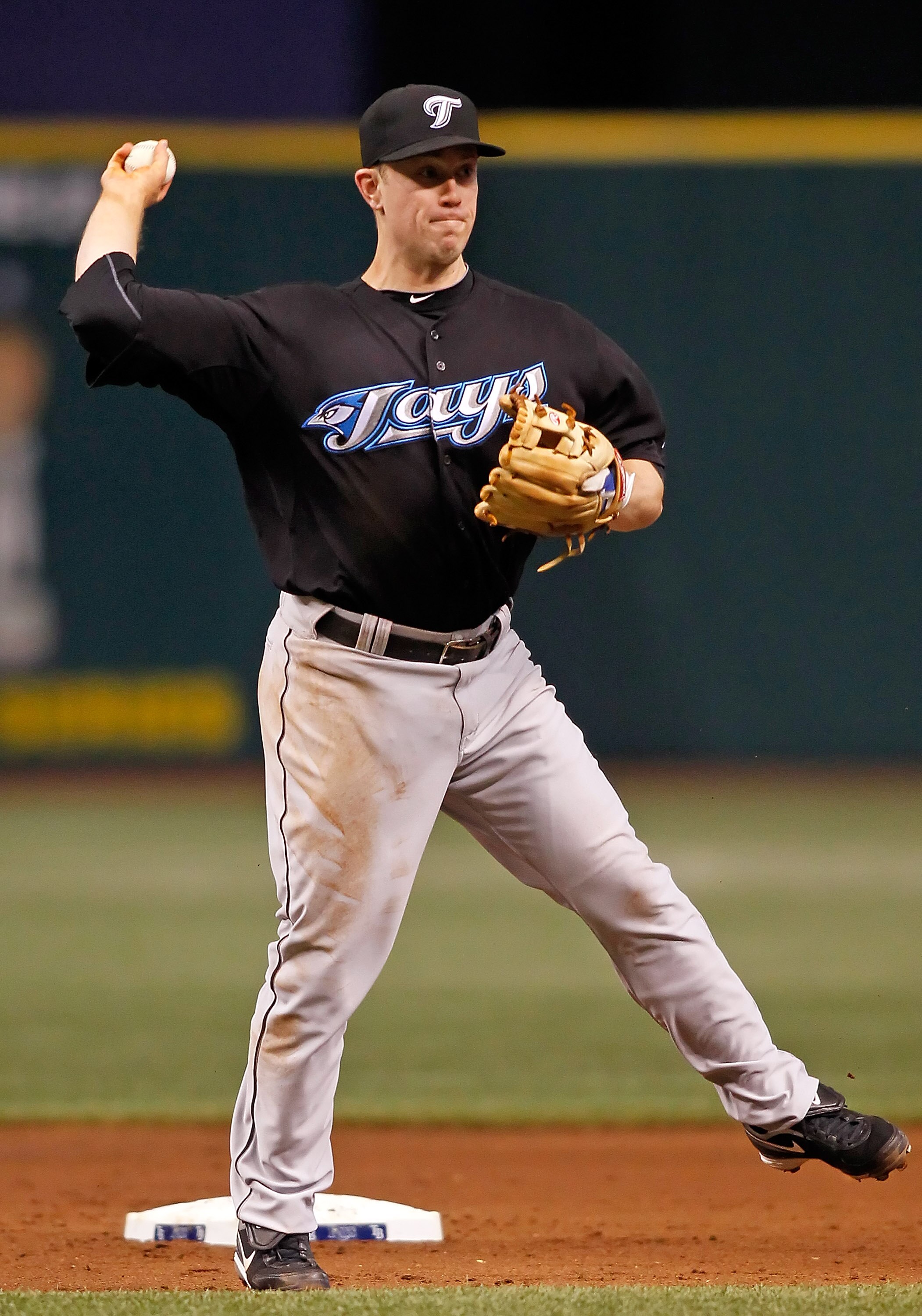 ST. PETERSBURG - JUNE 10:  Infielder Aaron Hill #2 of the Toronto Blue Jays throws over to first for an out against the Tampa Bay Rays during the game at Tropicana Field on June 10, 2010 in St. Petersburg, Florida.  (Photo by J. Meric/Getty Images)