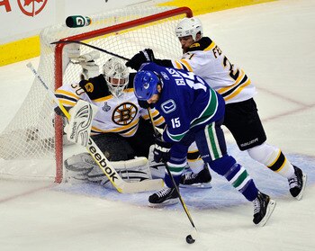 VANCOUVER, BC - JUNE 15:  Tim Thomas #30 of the Boston Bruins tends goal against Tanner Glass #15 of the Vancouver Canucks during Game Seven of the 2011 NHL Stanley Cup Final at Rogers Arena on June 15, 2011 in Vancouver, British Columbia, Canada.  (Photo