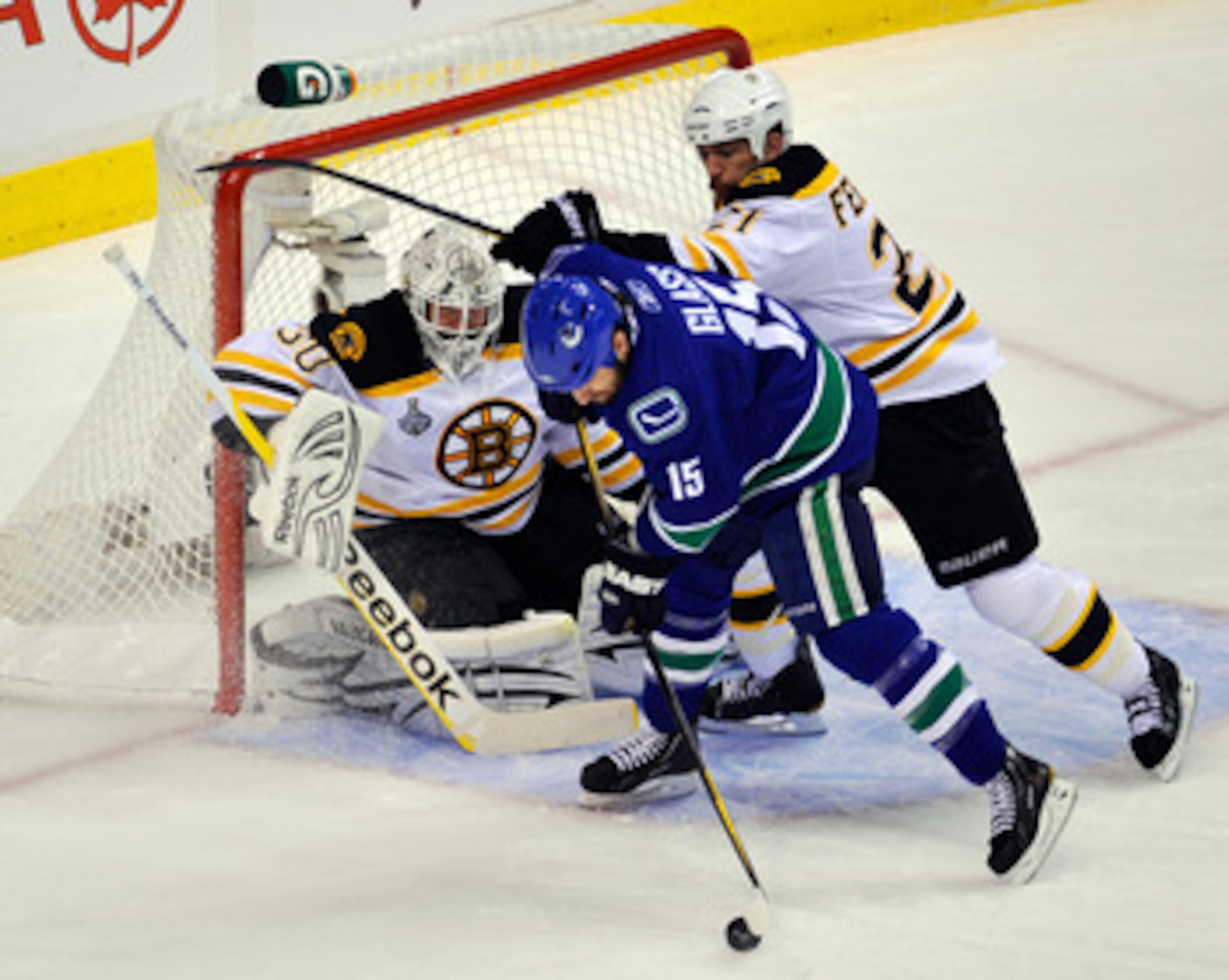 VANCOUVER, BC - JUNE 15:  Tim Thomas #30 of the Boston Bruins tends goal against Tanner Glass #15 of the Vancouver Canucks during Game Seven of the 2011 NHL Stanley Cup Final at Rogers Arena on June 15, 2011 in Vancouver, British Columbia, Canada.  (Photo