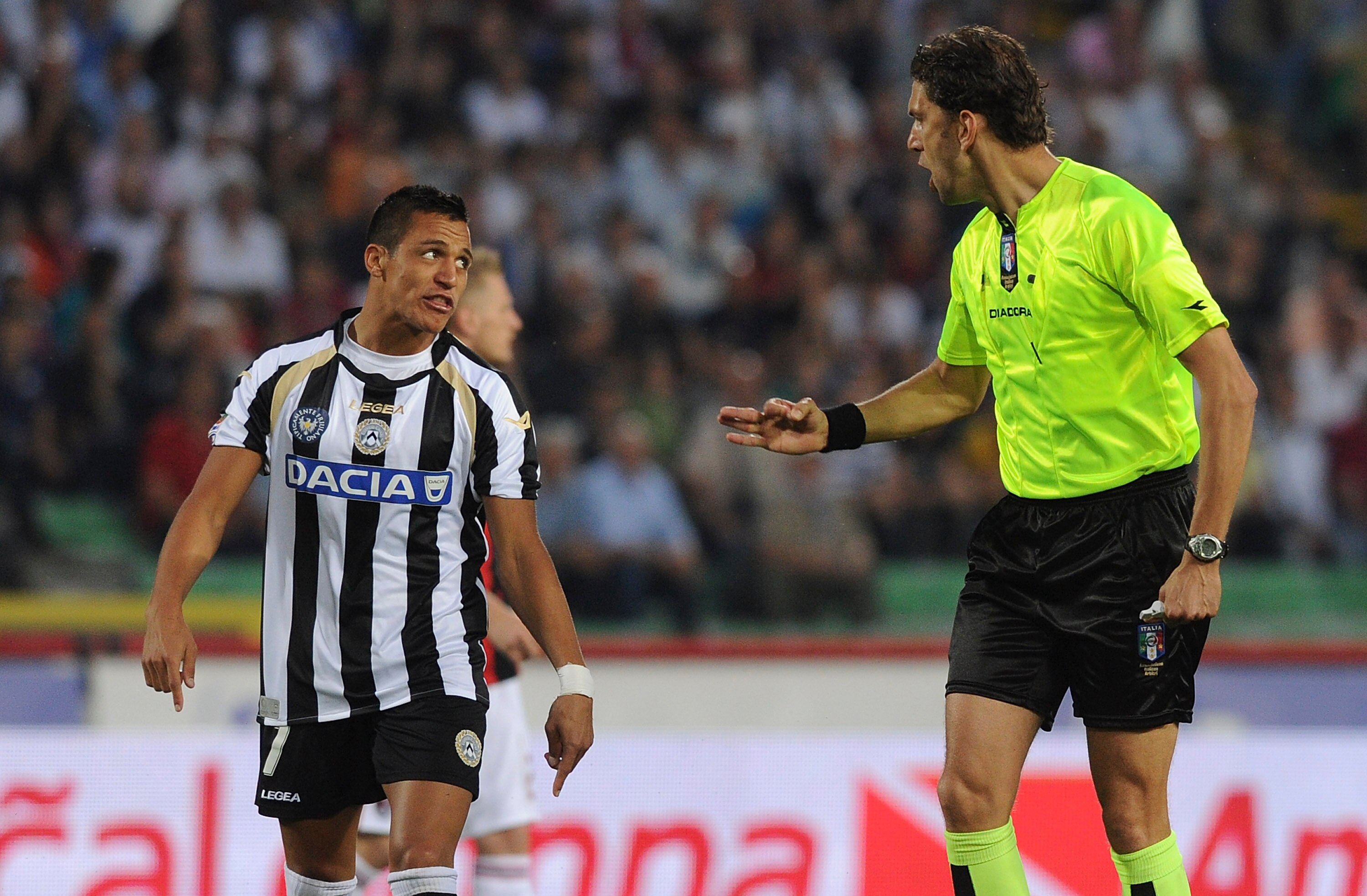 UDINE, ITALY - MAY 22:  Referee Paolo Tagliavento (R) talks with Alexis Samnchez of Udinese during the Serie A match between Udinese Calcio and AC Milan  at Stadio Friuli on May 22, 2011 in Udine, Italy.  (Photo by Dino Panato/Getty Images)