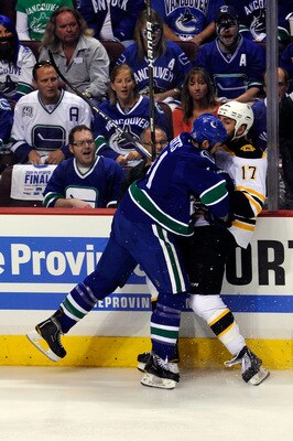 VANCOUVER, BC - JUNE 10:  Andrew Alberts #41 of the Vancouver Canucks checks Milan Lucic #17 of the Boston Bruins during Game Five of the 2011 NHL Stanley Cup Final at Rogers Arena on June 10, 2011 in Vancouver, British Columbia, Canada.  (Photo by Rich L