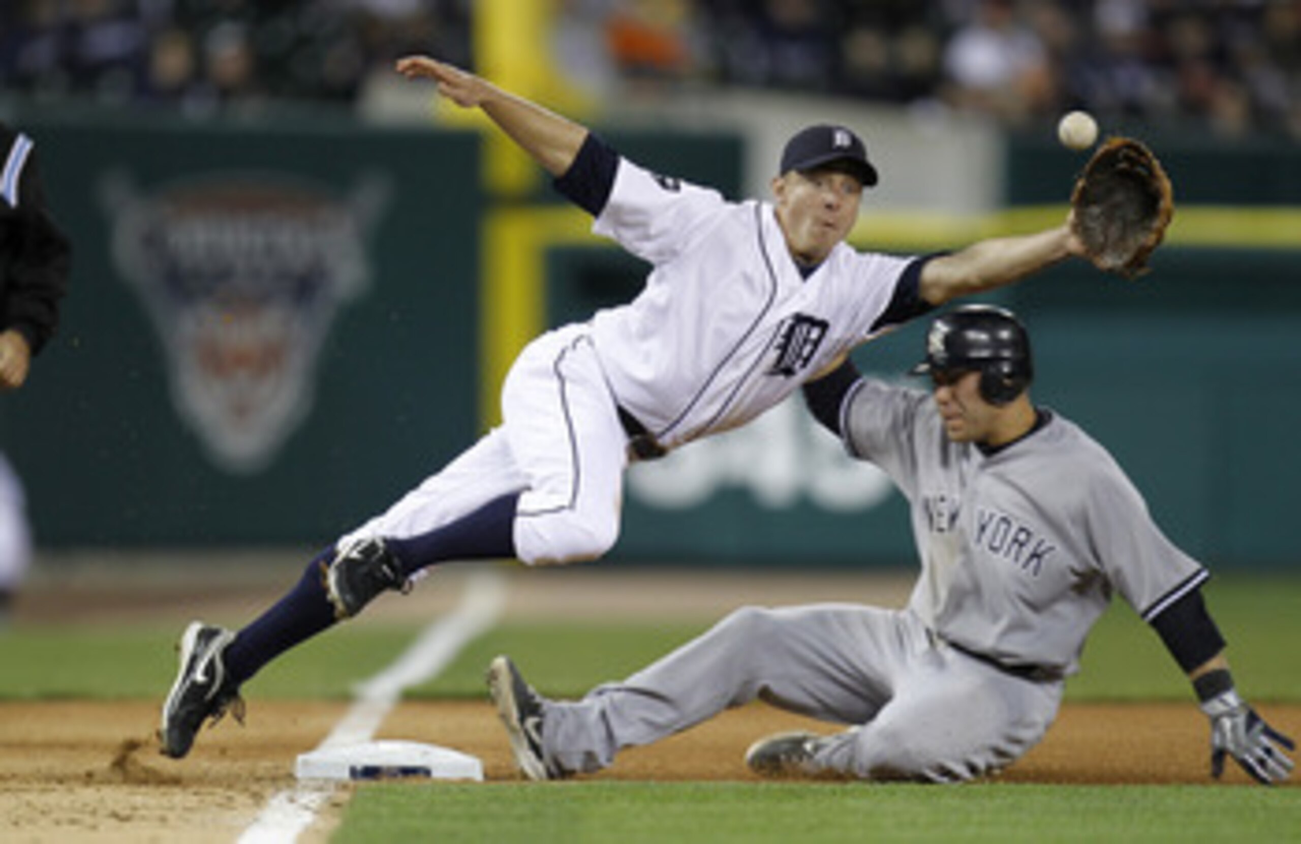 DETROIT, MI - MAY 02:  Brandon Inge #15 of the Detroit Tigers can't pull in a throw from Alex Avila #13 after a wild pitch in front of Russell Martin #55 of the New York Yankees at Comerica Park on May 2, 2011 in Detroit, Michigan. New York won the game 5