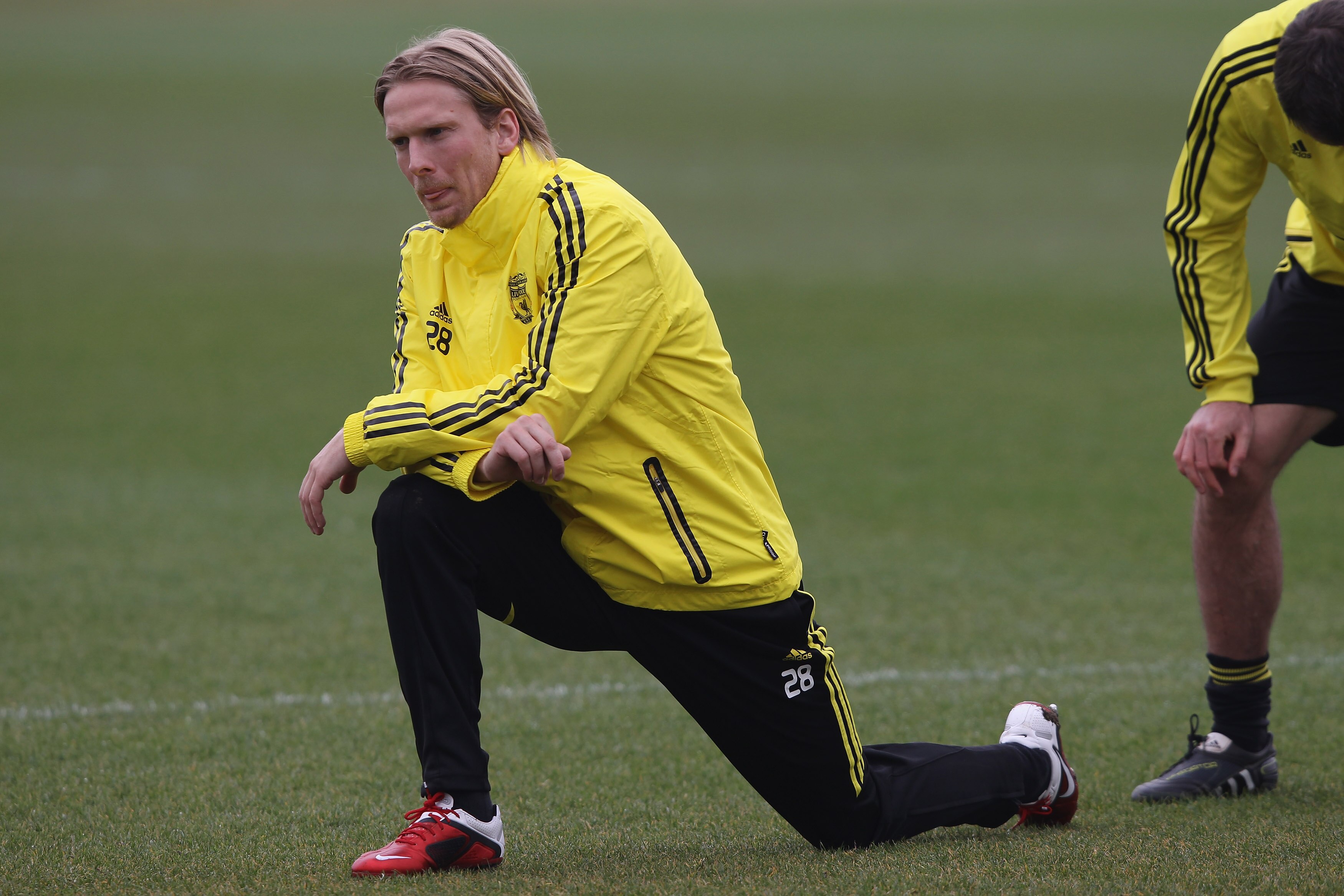 LIVERPOOL, ENGLAND - MARCH 16: Christian Poulsen of Liverpool stretches during a training session ahead of their UEFA Europa League Round of 16 second leg match against Braga at Melwood Training Ground on March 16, 2010 in Liverpool, England.  (Photo by C